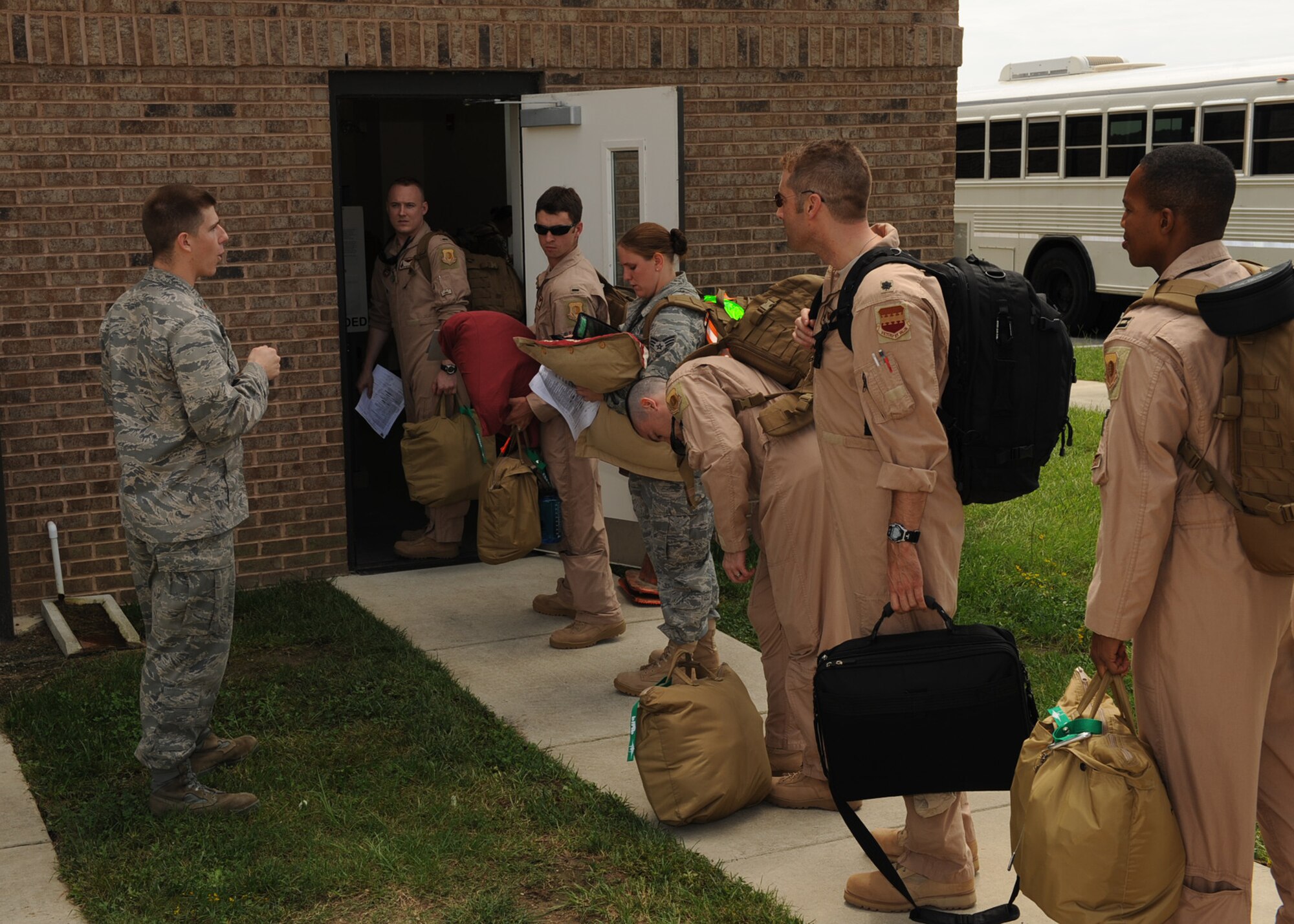 2nd Lt. Mark Honnen (left), 4th Force Support Squadron personnel deployment function, briefs Airmen from the 335th Fighter Squadron and 4th Maintenance Group before they deploy to Afghanistan from Seymour Johnson Air Force Base, N.C., Sept. 1, 2009. The Airmen deployed to relieve the 336th Fighter Squadron and fellow 4th MXG maintainers. (U.S. Air Force photo by Senior Airman Ciara Wymbs)