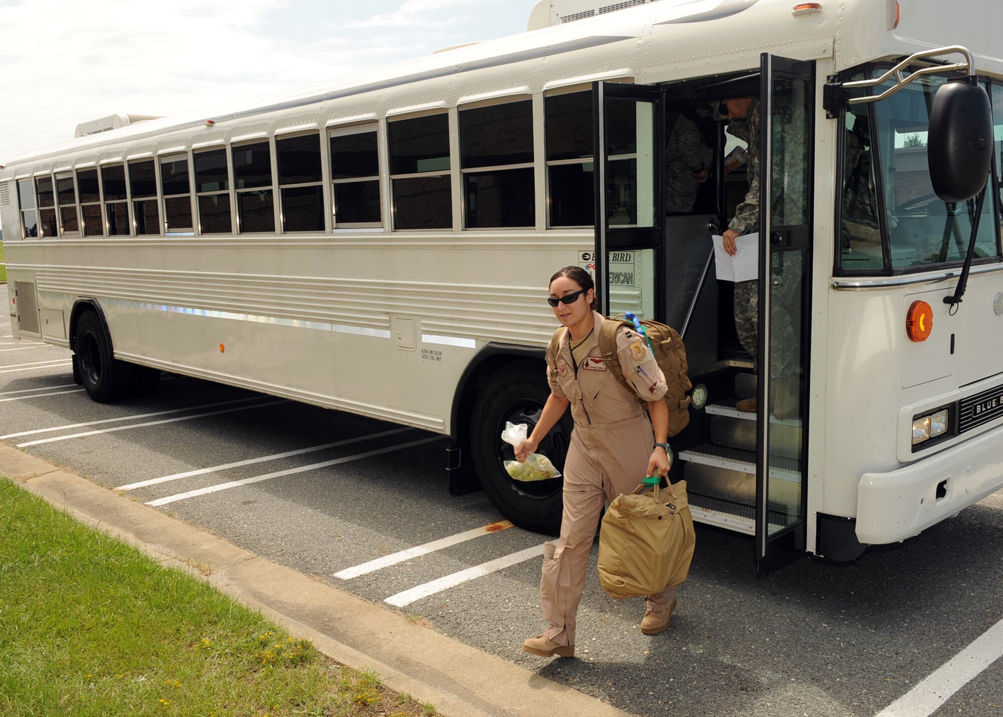 Capt. Crystal Kirkley, 335th Fighter Squadron weapons system officer, exits a bus before deploying to Afghanistan from Seymour Johnson Air Force Base, N.C., Sept. 1, 2009. Capt. Kirkley deployed with more than 70 Airmen from the 335th FS and 4th Maintenance Group who are relieving Airmen from the 336th Fighter Squadron and fellow maintainers who are set to return home in September. (U.S. Air Force photo by Senior Airman Ciara Wymbs)
