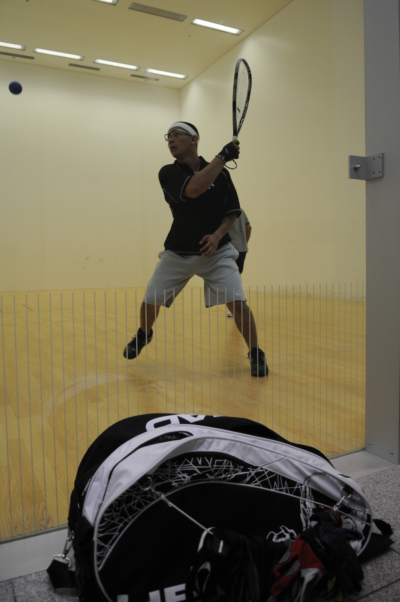 U.S. Air Force Airman 1st Class Grovert Fuentes-Contreras, 86th Airlift Wing Public Affairs photographer, prepares to hit the ball while playing racquetball at the Southside Fitness Center, Aug. 25, 2009, Ramstein Air Base, Germany. Racquetball is one of the many ways Airmen are keeping in shape. (U.S. Air Force photo by Airman 1st Class Alexandria Mosness)