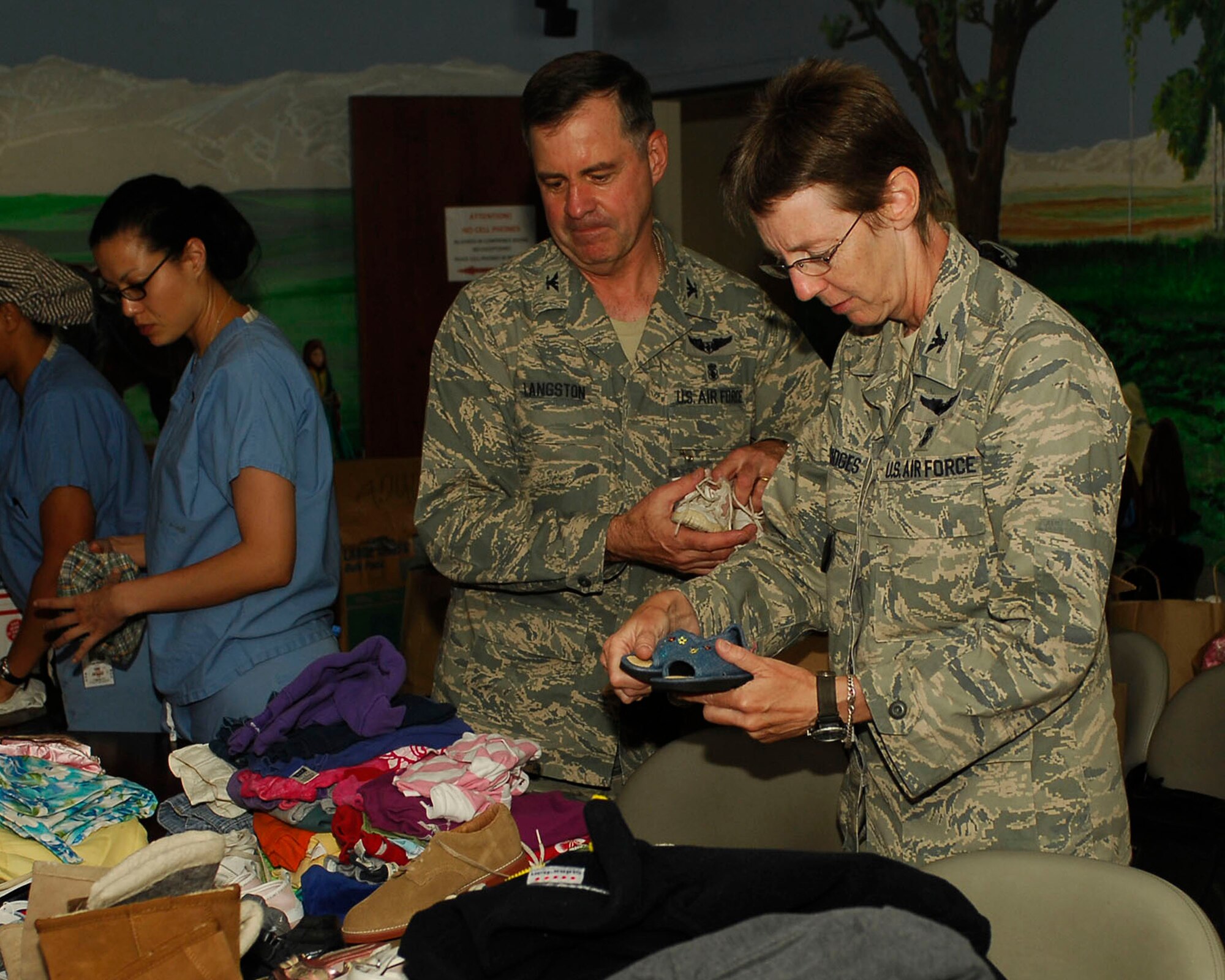 BAGRAM AIRFIELD, Afghanistan -- Members of Joint Task Force MED east/455th Expeditionary Medical Group take time out of their busy days to participate in a humanitarian aid packing party here, Aug. 29, 2009.  The members pack an assortment of things from candies to jackets to toys and different clothes for Afghan people.   Task Force Med from the Craig Joint Theater Hospital helps a variety of patients to include U.S. and coalition forces, local nationals, the Afghan National Army and Afghan police.  (U.S. Air Force photo/Senior Airman Felicia Juenke)