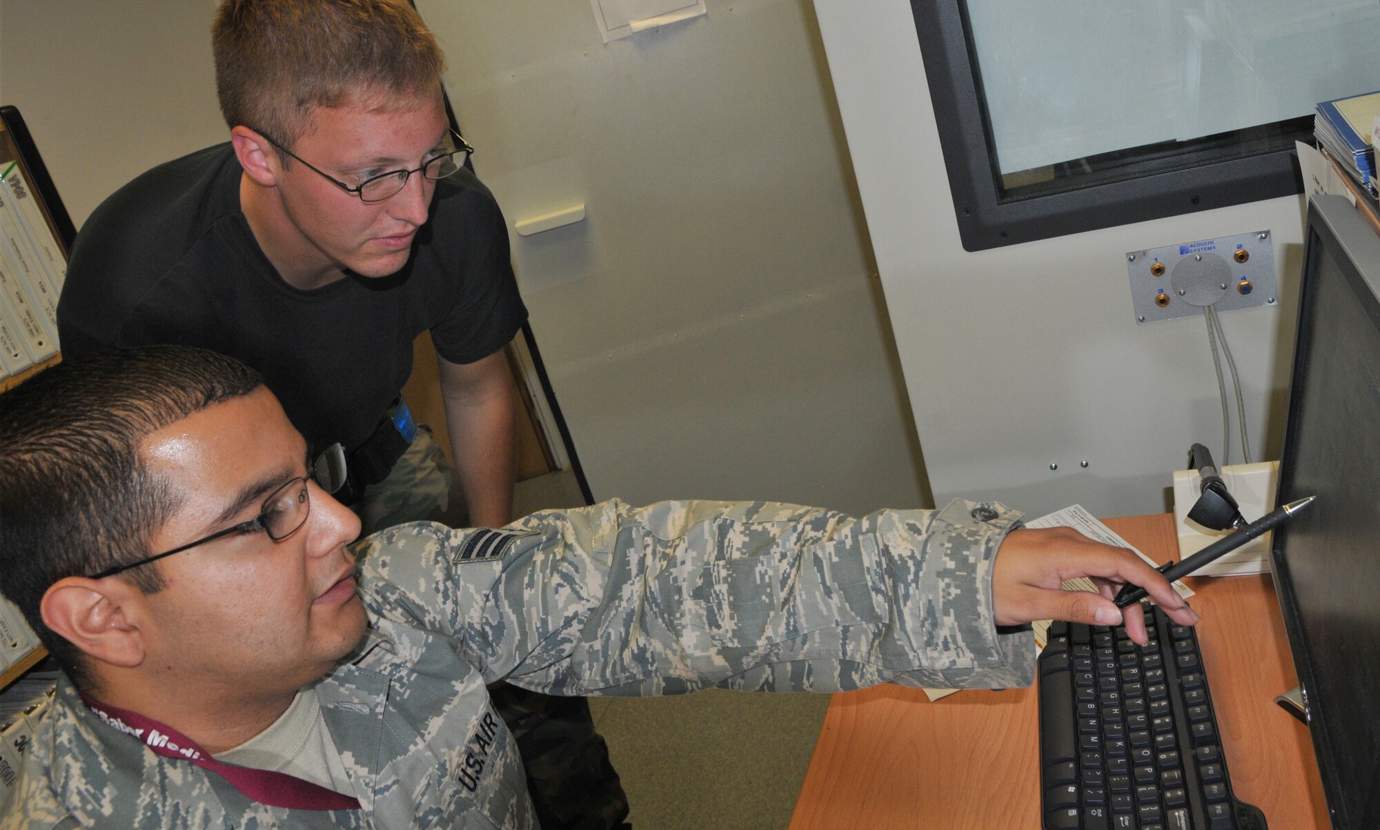 SPANGDAHLEM AIR BASE, Germany -- Public Health Technician Senior Airman David A. Chavez, 52nd Aerospace Medicine Squadron, gives a briefing to Staff Sgt. Adam S. Vogt, 23rd Aircraft Maintenance Unit, about his hearing exam Sept. 1. Airman Chavez gives hearing tests to find trends in standard threshold shifts to see if patients are being exposed to hazardous noises. He then shows his patients a graph tracking how much their hearing has improved or how much their hearing has decreased. He also educates them on ways to keep from being exposed to certain hearing hazards on and off duty. (U.S. Air Force photo/Airman 1st Class Nick Wilson)