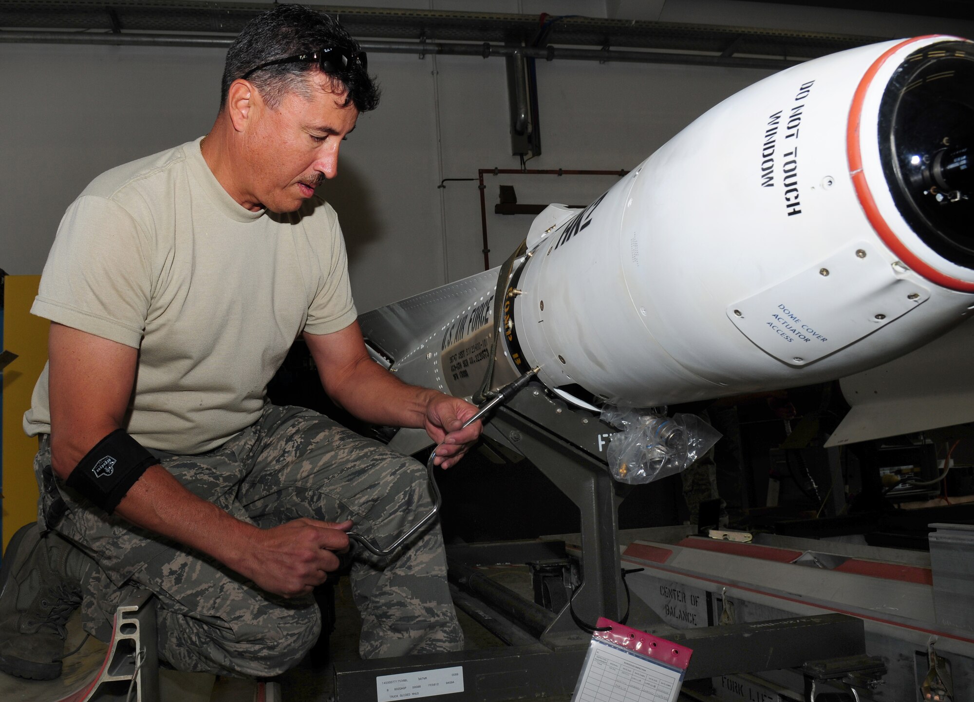 U.S. Air Force Master Sgt. Eugene Rinaldi, Air Force Reserve Ammunition Team member, removes the guidance control section of an AGM-65 Maverick missile system for upgrades Aug. 11, 2009, Ramstein Air Base, Germany. Each missile weighs either 466 or 654 pounds, depending on the model. (U.S. Air Force photo by Staff Sgt. Jocelyn Rich)