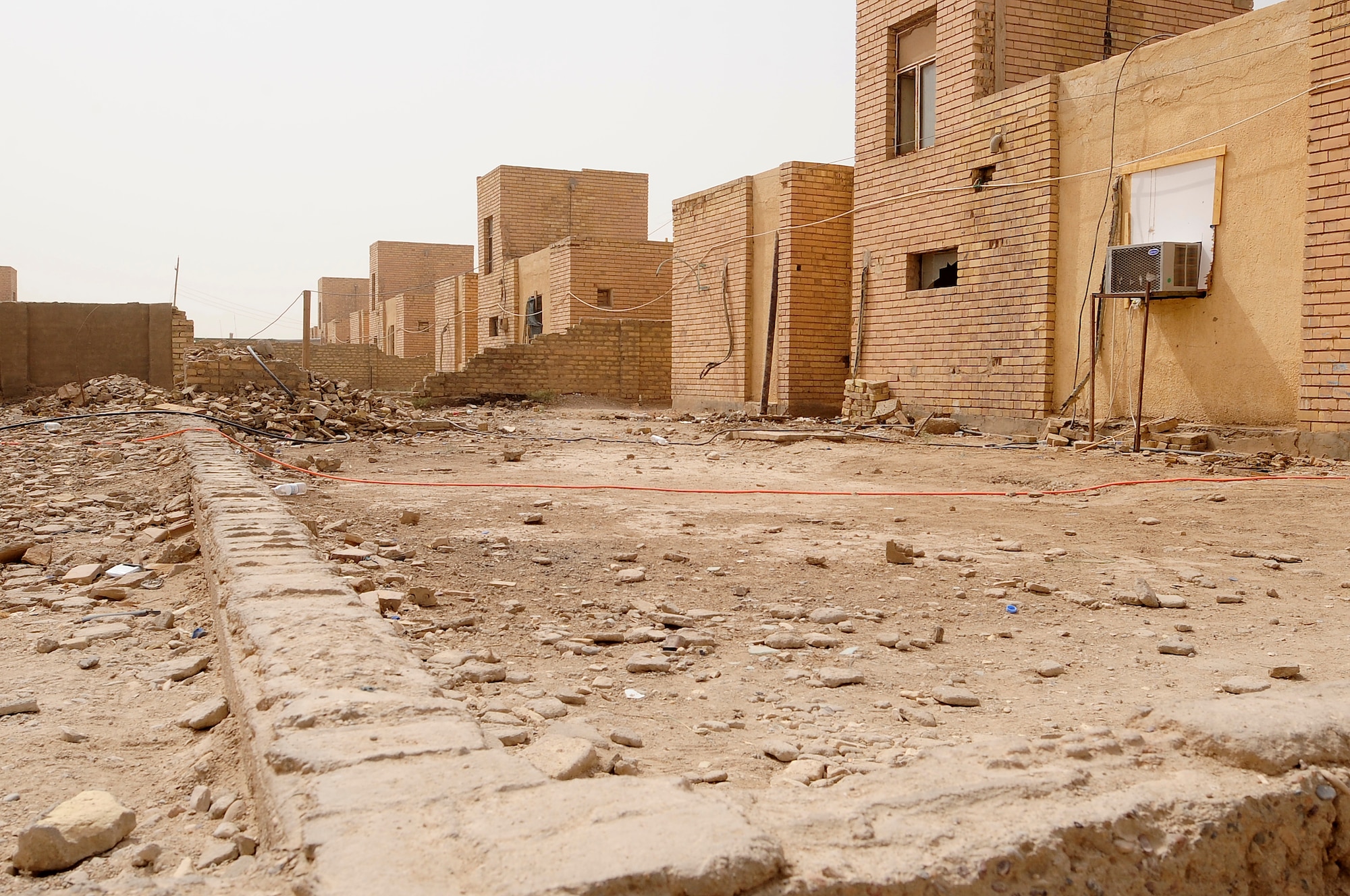 ALI BASE, Iraq – Rubble littering the streets of Camp Mittica, Iraq provides images of the once war torn area.  Recently, Airmen from the 407th Expeditionary Force Support Squadron donated more than 70 bed frames and mattresses to the 10th Iraqi Army Division there.  Prior to the donation Iraqi Soldiers slept on the floor or rooftops of their facilities with a thin pad as their bed. (U.S. Air Force photo / Airman 1st Class Tony R. Ritter) (Released)