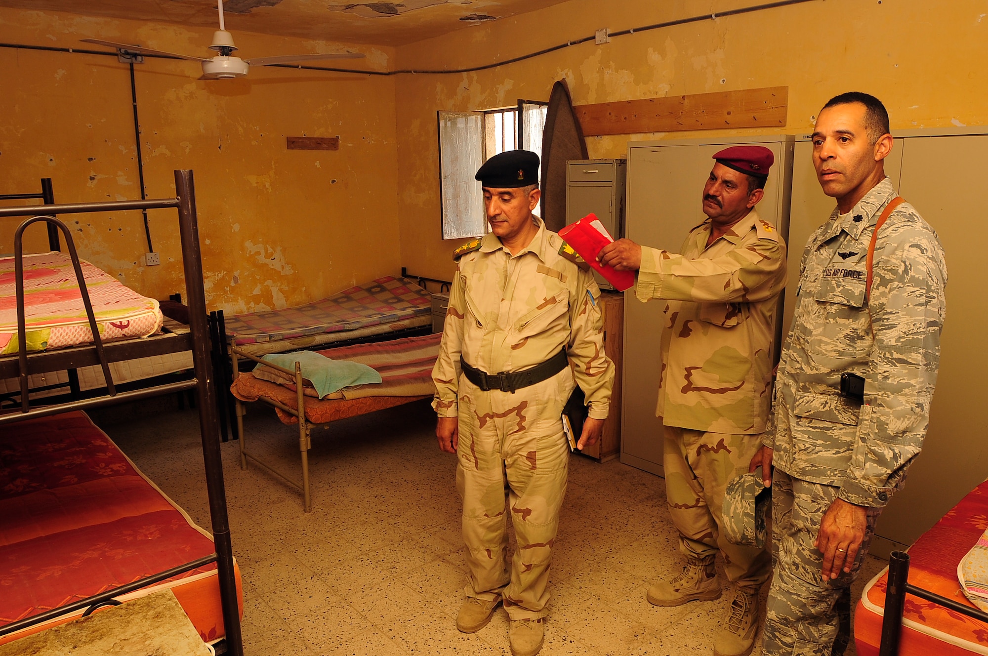 ALI BASE, Iraq - Members of the 10th Iraqi Army Division provide Lt. Col. Bradford Montgomery, 407th Expeditionary Force Support Squadron commander, a tour of Camp Mittica, Iraq, Aug. 29, 2009. Colonel Montgomery, deployed from Naval Air Station Joint Reserve Base Ft. Worth, Texas, and Airmen from the 407th EFSS donated more than 70 bed frames and mattresses to the Iraqi Army assigned to Camp Mittica. Prior to the donation Iraqi Soldiers slept on the floor or rooftops of their facilities using only a thin pad as their bed. (U.S. Air Force photo/Senior Airman Tony R. Ritter) 