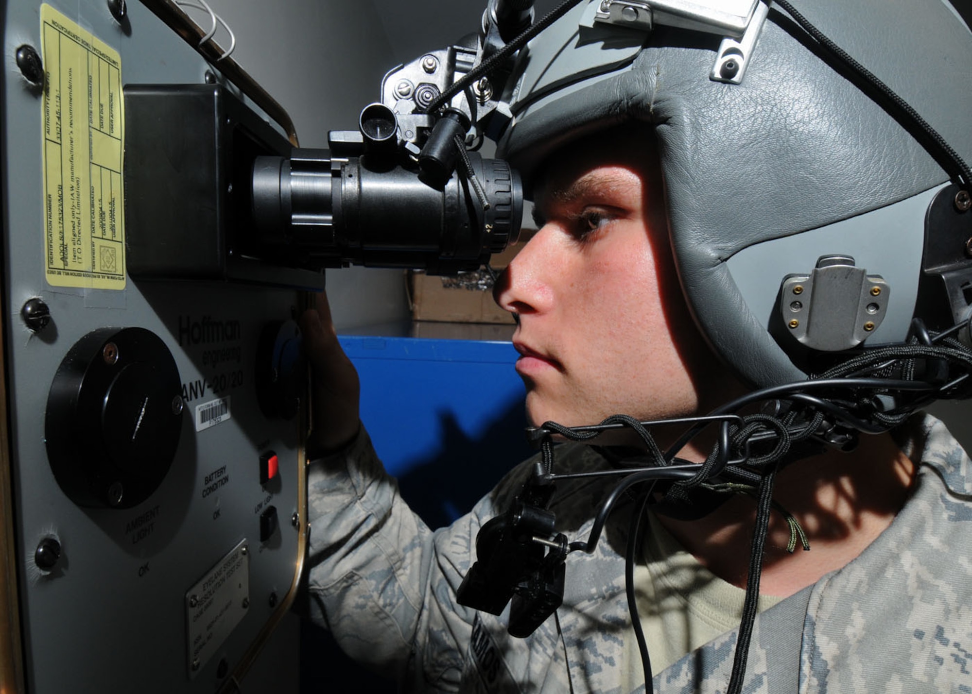YOKOTA AIR BASE, Japan -- Airman 1st Class Matthew Ramos, 374th Operations Support Squadron aircrew flight equipment apprentice, test a pair of night vision goggles with an aircrew night vision 20/20 tester Sept. 2.  Aircrew flight equipment  technicians ensure life-saving survival equipment used by aircrew members is properly functioning by inspecting and maintaining items such as flight helmets, oxygen masks, parachutes, flotation devices, survival kits, helmet mounted devices, aircrew night vision and other ocular systems. They also check anti-gravity garments, aircrew eye and respiratory protective equipment, chemical biological protective oxygen masks and coveralls, and other types of aircrew flight equipment and aircrew chemical defense systems. (U.S. Air Force photo/Staff Sgt. Veronica Pierce)