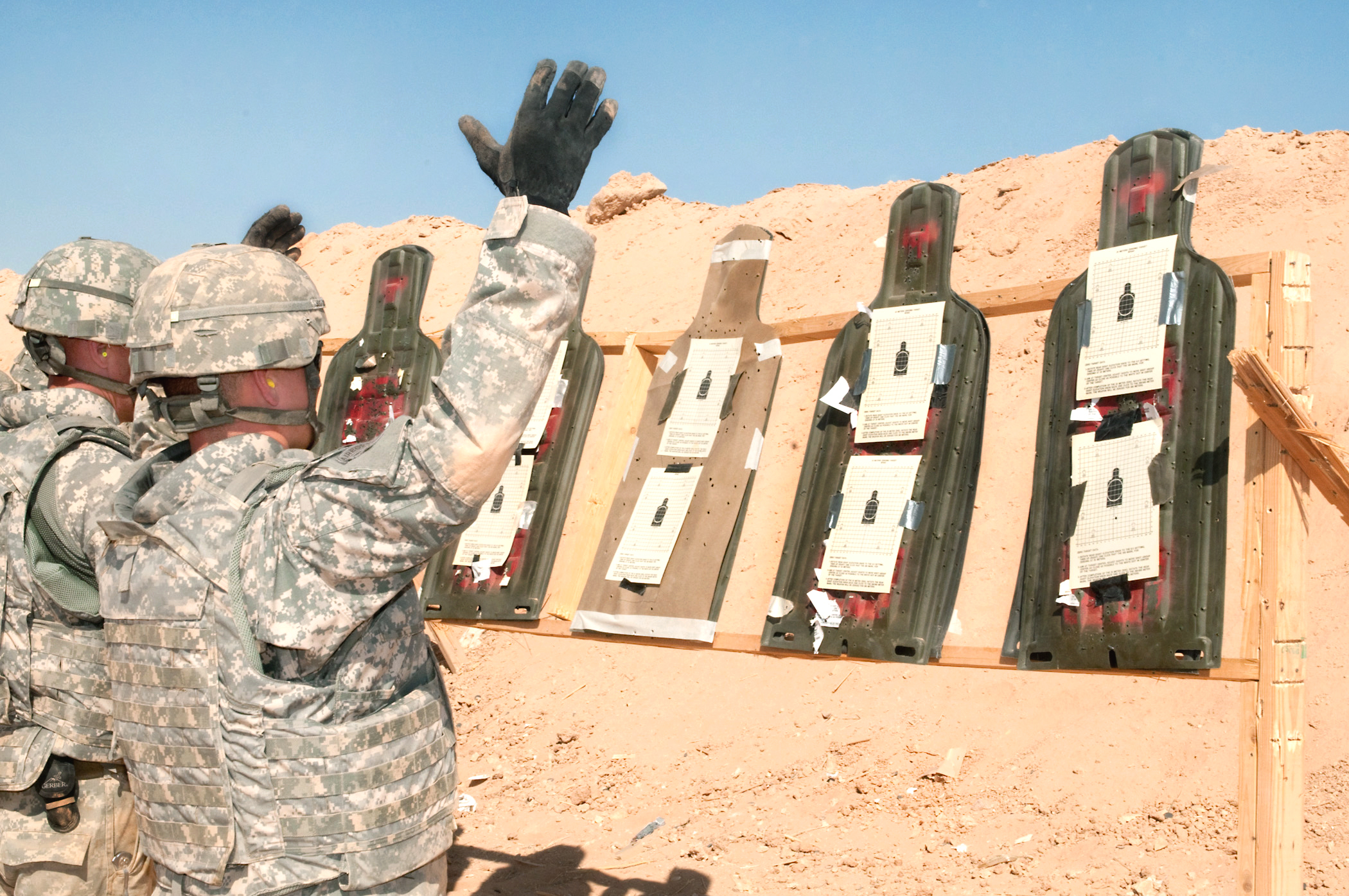 A U.S. Army paratrooper celebrates the results of his zeroing shots on
