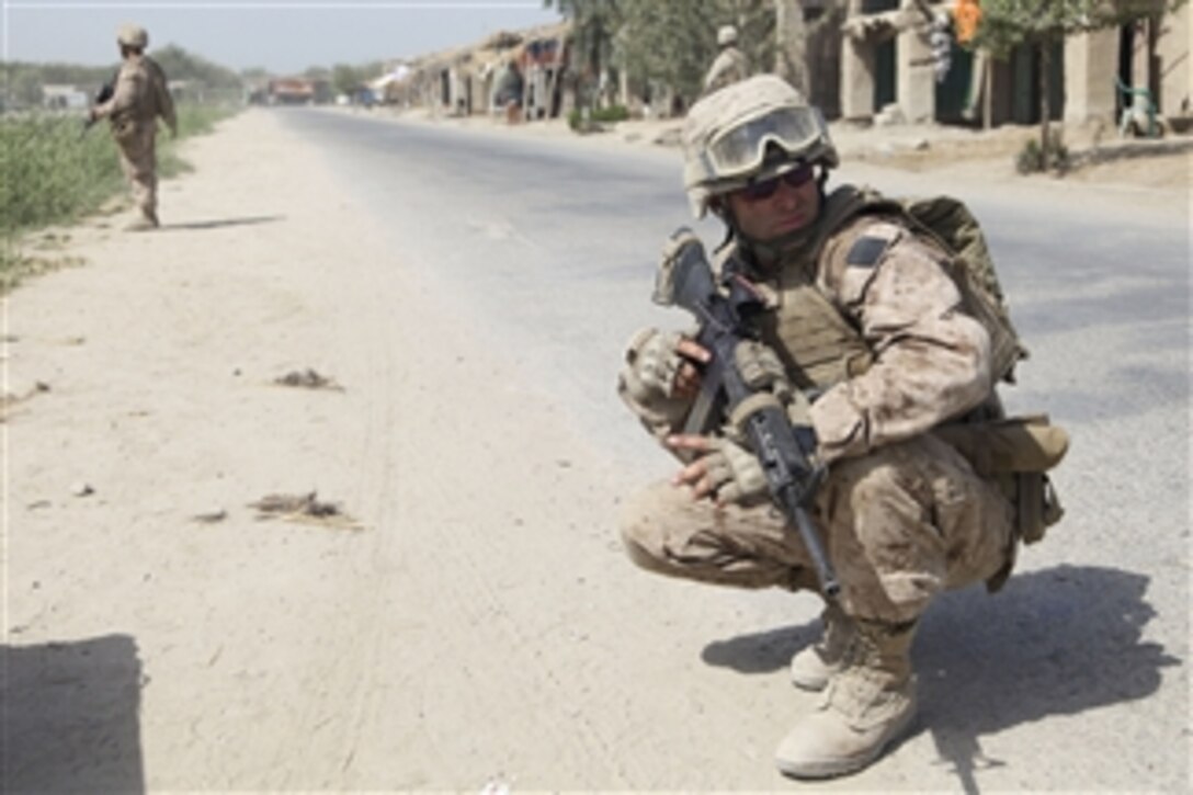 U.S. Marine Corps Cpl. Christopher Mullins with 1st Battalion, 5th Marine Regiment provides security during a patrol in Nawa district, Helmand province, Afghanistan, on Aug. 30, 2009.  The 1st Battalion is deployed with Regimental Combat Team 3 to conduct counterinsurgency operations in partnership with the Afghan security forces in southern Afghanistan.  