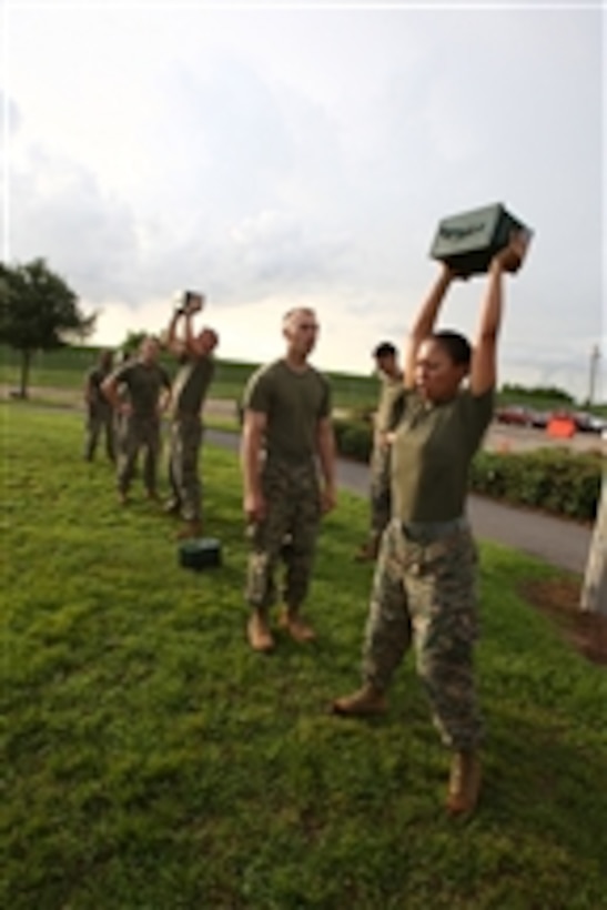 U.S. Marines with Headquarters Battalion, Marine Forces Reserve lift ammo cans over their heads during a combat fitness test in New Orleans, La., on Aug. 18, 2009.  Individual readiness is measured by requiring Marines in battle dress uniform to sprint a timed 880 yards, lift a 30-pound ammunition can overhead from shoulder height repeatedly for two minutes and perform a maneuver-under-fire event, which is a timed 300-yard shuttle run in which Marines perform a series of combat-related tasks.  