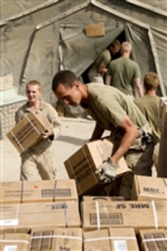 U.S. Marines with Charlie Company, 1st Battalion, 5th Marine Regiment load boxes of meals, ready to eat in the back of a trailer at Patrol Base Jaker, in Nawa district, Helmand province, Afghanistan, on Aug. 30, 2009.  The 1st Battalion is deployed with Regimental Combat Team 3 to conduct counterinsurgency operations in partnership with the Afghan security forces in southern Afghanistan.  