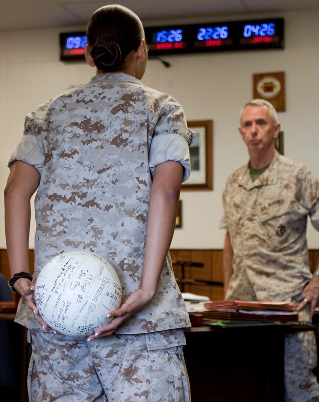 Col. Terry Brady, G-1 Assistant Chief of Staff, U.S. Marine Corps Forces, Pacific, addresses one of his Marines about a recent PME Sept. 4, at MarForPac.  Symbolizing years of Brady's intricate military education lessons, and the need for an assistant sworn to secrecy to facilitate the coordinating efforts, the ball was handed down from helper onward until Brady's last class, Sept. 3. A typical class consisted of months of careful planning, sometimes reserving helicopters or other training areas, blindfolding all participants, and taking them to an uknown location for the day's focus, ranging from historical events - to modern day problems such as human trafficking. As Brady prepares to retire after 38 years of service Sept. 11, his well-known educational approach is one of the many aspects he leaves behind, and possibly his favorite.