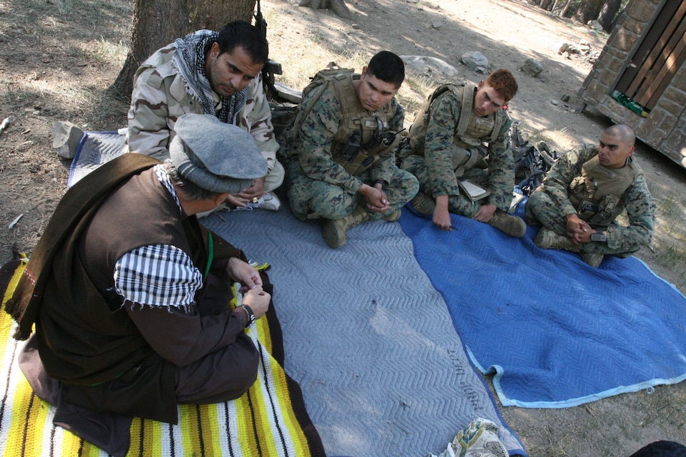 MARINE CORPS MOUNTAIN WARFARE TRAINING CENTER BRIDGEPORT, Calif. – Marines with 3rd Battalion, 7th Marine Regiment, talk with Afghan role players during a key leader engagement during the battalion's final exercise here Sept. 4. The Marines were responsible for ridding each simulated village of insurgent activity and helping the villagers with water, construction and other financial problems the communities faced.