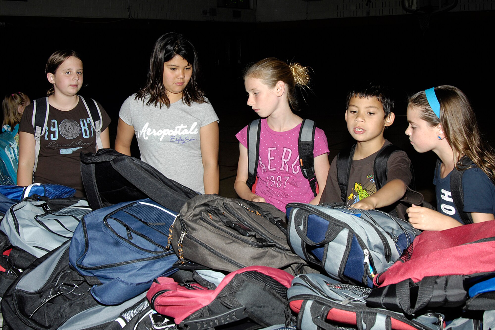 HANSCOM AIR FORCE BASE, Mass. – Hanscom students sort through backpacks at the Youth Center on Sept. 1, looking for just the right one to head back to school. Operation Homefront donated the school supplies and backpacks to military children in grades kindergarten through high school.   (U.S. Air Force photo by Linda LaBonte Britt) 