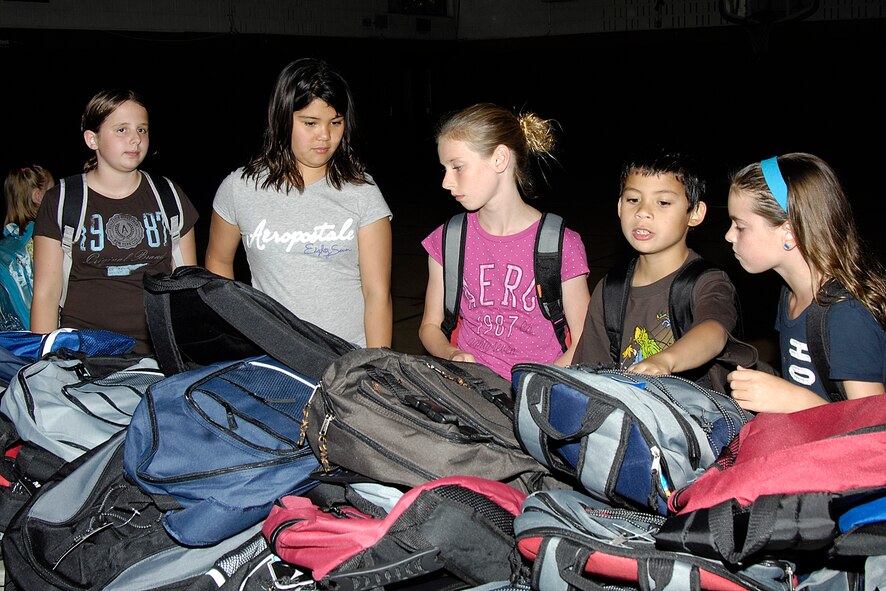 HANSCOM AIR FORCE BASE, Mass. – Hanscom students sort through backpacks at the Youth Center on Sept. 1, looking for just the right one to head back to school. Operation Homefront donated the school supplies and backpacks to military children in grades kindergarten through high school.   (U.S. Air Force photo by Linda LaBonte Britt) 