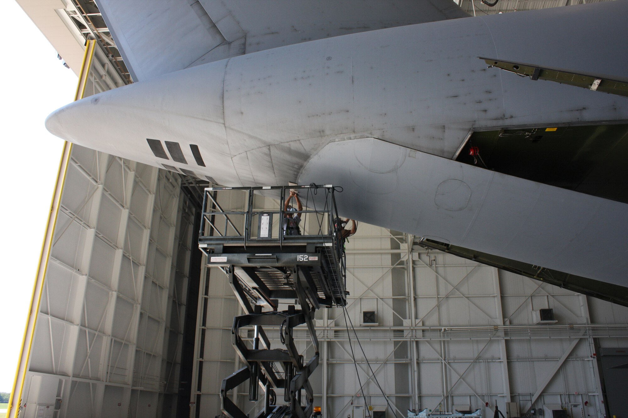 WRIGHT-PATTERSON AIR FORCE BASE, Ohio – Staff Sgt. Thomas Penner, left, and Master Sgt. Richard Gerhardt, both from the 445th Maintenance Squadron structural maintenance shop, work together to trim the door that is being installed on a C-5 Galaxy aircraft. The C-5 is one of the largest aircraft in the world and the largest airlifter in the Air Force inventory. (U. S. Air Force photo/Stacy Vaughn)