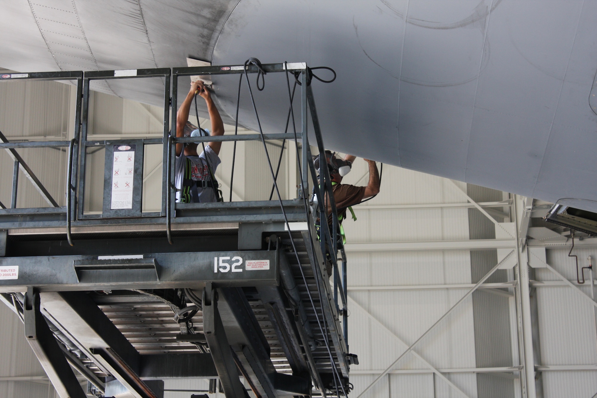 WRIGHT-PATTERSON AIR FORCE BASE, Ohio – Staff Sgt. Thomas Penner, left, and Master Sgt. Richard Gerhardt, both from the 445th Maintenance Squadron structural maintenance shop, work together to trim the door that is being installed on a C-5 Galaxy aircraft. The C-5 is one of the largest aircraft in the world and the largest airlifter in the Air Force inventory. (U. S. Air Force photo/Stacy Vaughn)