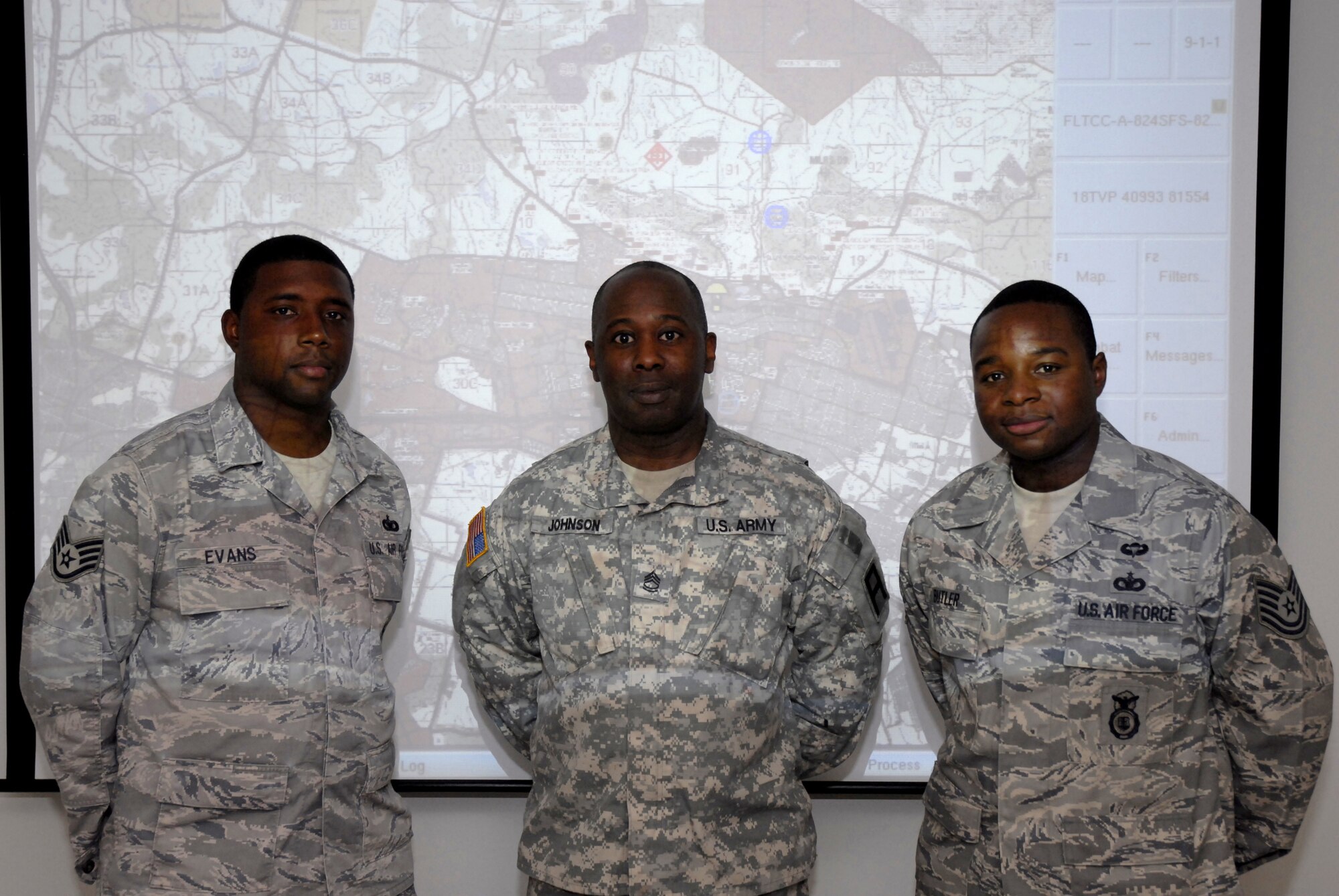 Contingency skills instructors Staff Sgt. Cecil Evans and Tech. Sgt. Shaylin Butler from the 421st Combat Training Squadron partner with U.S. Army Sgt. 1st Class Gary Johnson from the 3rd Training Support Battalion at Fort Meade, Md., to spearhead the creation of an Air Force program allowing Airmen to train Airmen in Blue Force Tracker at the U.S. Air Force Expeditionary Center, Fort Dix, N.J.  August 29, 2009.  Having Airmen training Airmen helps alleviate some of the demand placed on the Army by reducing the Air Force's demand for their training. (U.S. Air Force Photo/Tech. Sgt. Paul R. Evans)