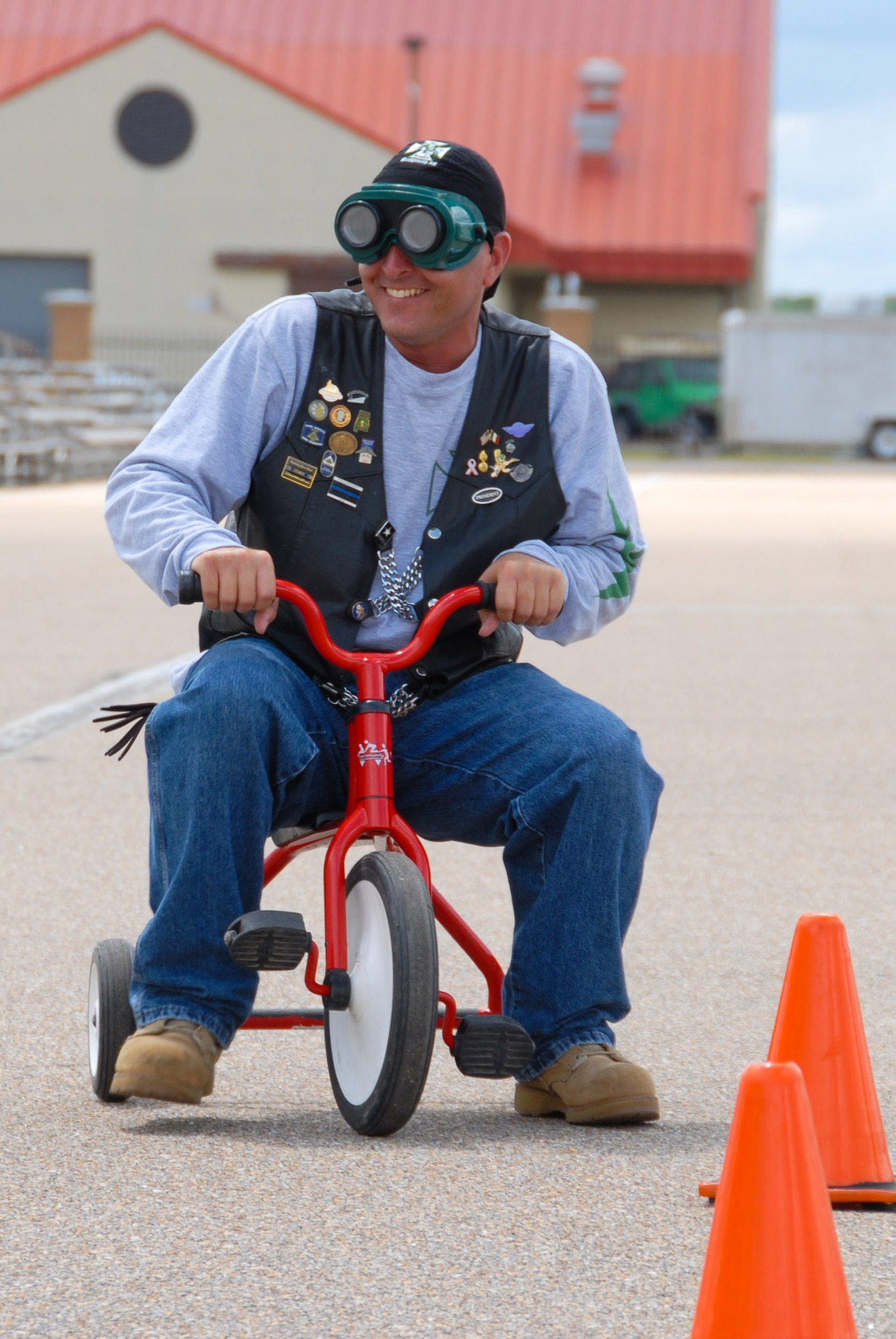 Green Knights Motorcycle Club president Dominic Gezzi, a technical sergeant at Gunter's 754th Electronic Systems Group, participates in the rally's final event, the tricycle race. (U.S. Air Force photo/Jamie Pitcher)