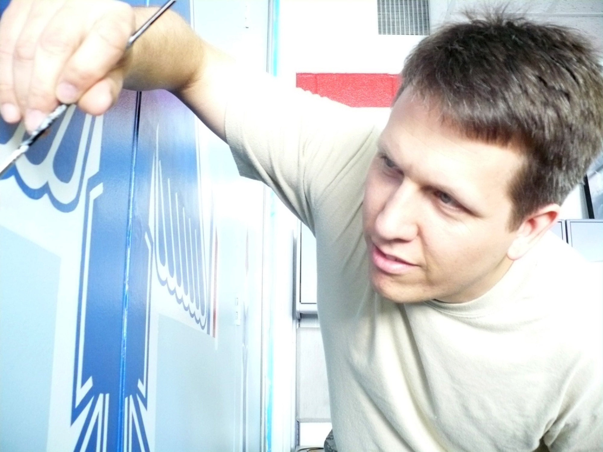 Maj. Jim Bodnar, University of Florida Air Force ROTC detachment 150 unit admissions officer, adds the finishing touches to the detachment's U.S.A.F. Thunderbirds wall mural. (Courtesy photo)