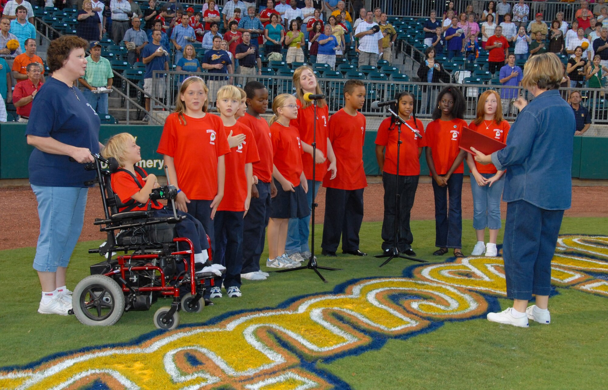Students from the Maxwell Elementary School started off one of the last home games of the Montgomery Biscuits Tuesday night by singing the national anthem. The Biscuits are a minor league, Double A, baseball team, affiliated with the Tampa Bay Rays. Shown from left are school principal Melissa Hayes, Alexis Butler, Brittany Butler, Adam Peck, Sommer Bauman, Jordan Sheppard, Katie Beasley, Cody Thompson, Zach DaSilva, Micaiah Bulluck, Essence Price, Madison Humphrey and music teacher Fonda Brooks. (U.S. Air Force photo/Jamie Pitcher)