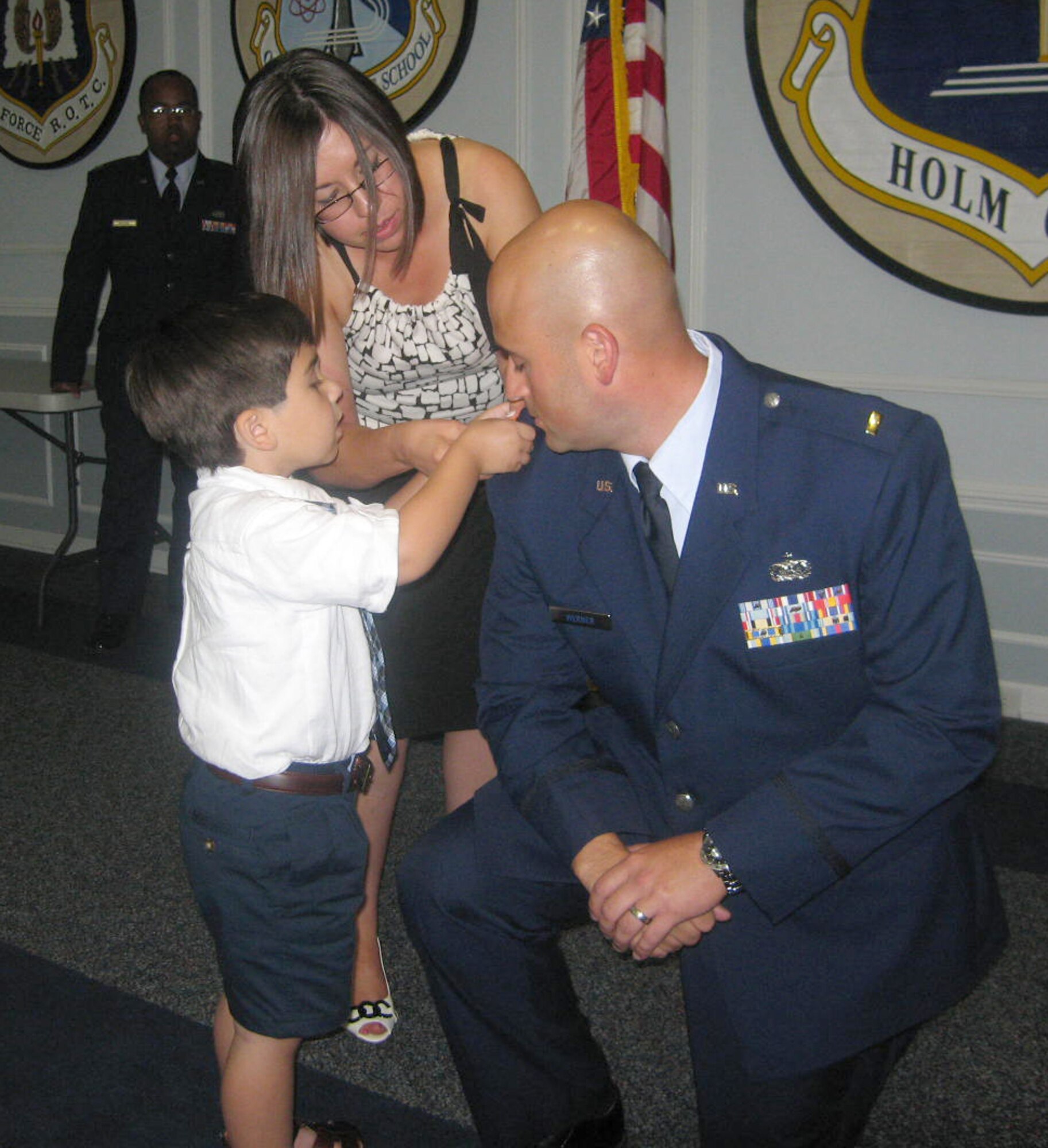 Newly "minted" 2nd Lt. Phillip "Ben" Werner, has his gold bars pinned on by his wife, Melanie, and his son, Max, on the occasion of his graduation from the 12-week long Officer Training School at Maxwell AFB, Ala., July 22. As the 442nd's newest commissioned officer, Lieutenant Werner made the transition to the officer corps after attaining the enlisted non-commissioned officer rank of technical sergeant while a member of the 442nd Security Forces Squadron.  (U.S. Air Force photo/Maj. Joe Walter