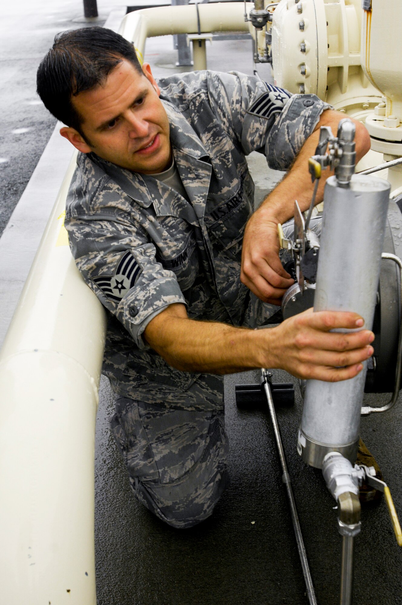 Staff Sgt. Jesse Winn regulates the amount of Plus 100 being blended into the JP-8 aviation fuel Sept. 1, 2009, at Elmendorf Air Force Base, Alaska. Base members began using Plus 100 additive in their JP-8 aviation fuel Sept. 1. The additive helps prevent buildup in F-15 Eagle and F-22 Raptor engines; therefore it will reduce the amount of maintenance needed on those engines. Sergeant Winn is assigned to the 3rd Logistics Readiness Squadron. (U.S. Air Force photo/Airman 1st Class Christopher Gross)