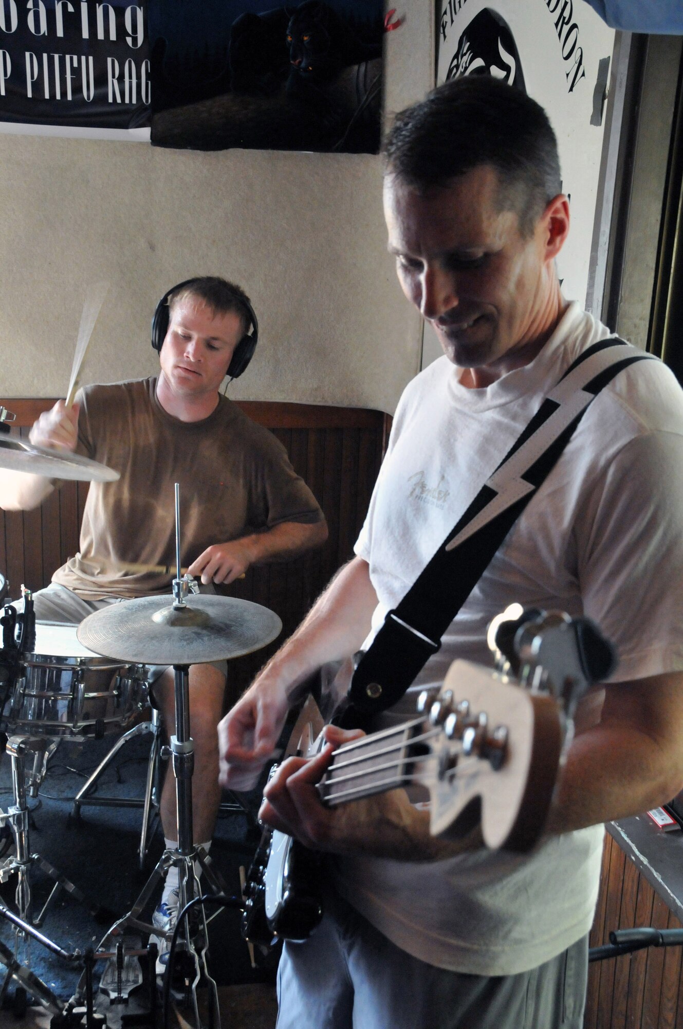 Capt. Kevin "Bama" Sweeney keeps the baseline beat on the drums while Lt. Col. Steve "Dallas" Horton fills with the bass during practice at Delta here at Kunsan Air Base, Republic of Korea, Aug. 9, 2009. Both are pilots with the 35th Fighter Squadron "Pantons," and members of the squadron's Steal Wool band. 