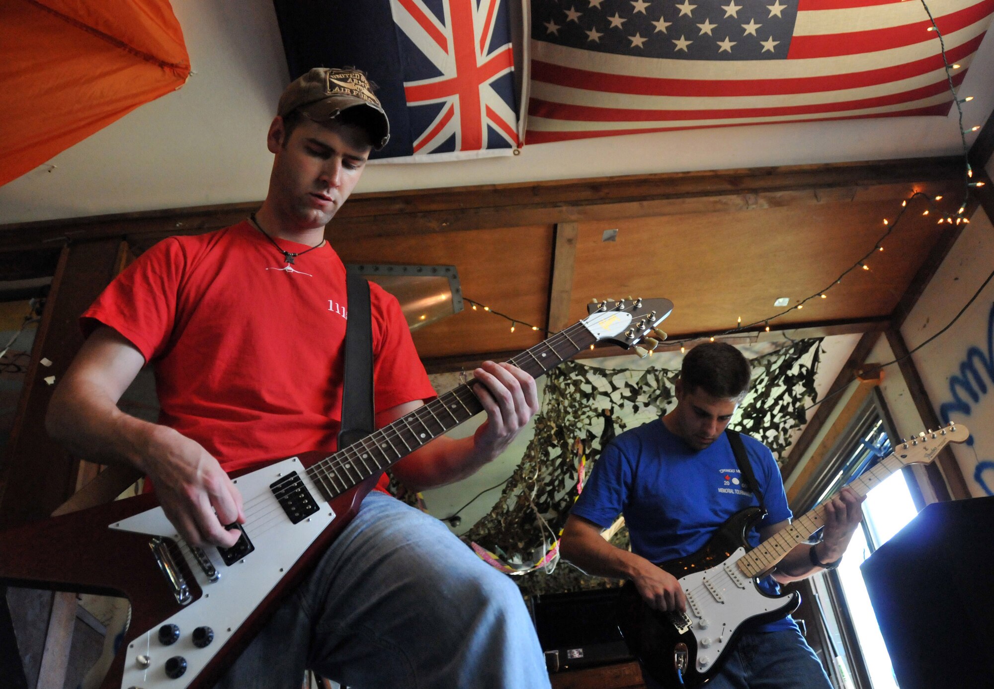 Capt. Alex "Tuna" Turner tunes into the electric guitar as Capt. Brad "Emcon" Brizek takes on lead guitar during band practice at Delta here at Kunsan Air Base, Republic of Korea, Aug. 9, 2009. Both captains are pilots with the 35th Fighter Squadron "Pantons," and members of the Steal Wool band.  
