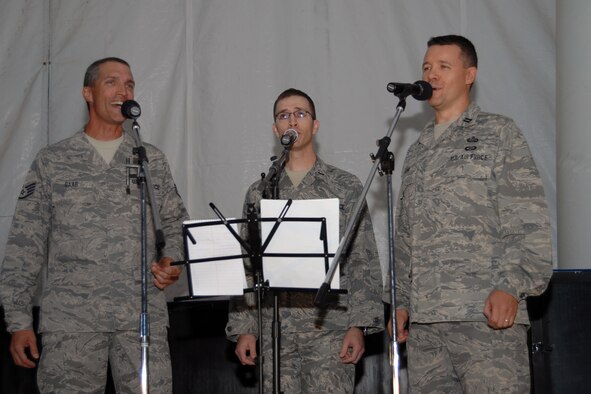 (Left to right) Staff Sgt. John Raab, 1st Lt. Jerry Underwood and Capt. Erik Stohl, members of the 506th Air Expeditionary Group, performed for more than 60 Airmen and Soldiers at the Clamtina Aug. 30 at Kirkuk Regional Air Base, Iraq. The trio, known as ‘3 Krab Night,’ formed after hearing each other sing the national anthem at different ceremonies here. The acappella band sang a variety of music from classic to modern. Sergeant Raab, a Colorado Springs, Colo., native, is deployed to the northern Iraqi base from the Air Force Reserve's 302nd Civil Engineer Squadron at Peterson Air Force Base, Colo. (U.S. Air Force photo/Staff Sgt. Joshua Breckon)