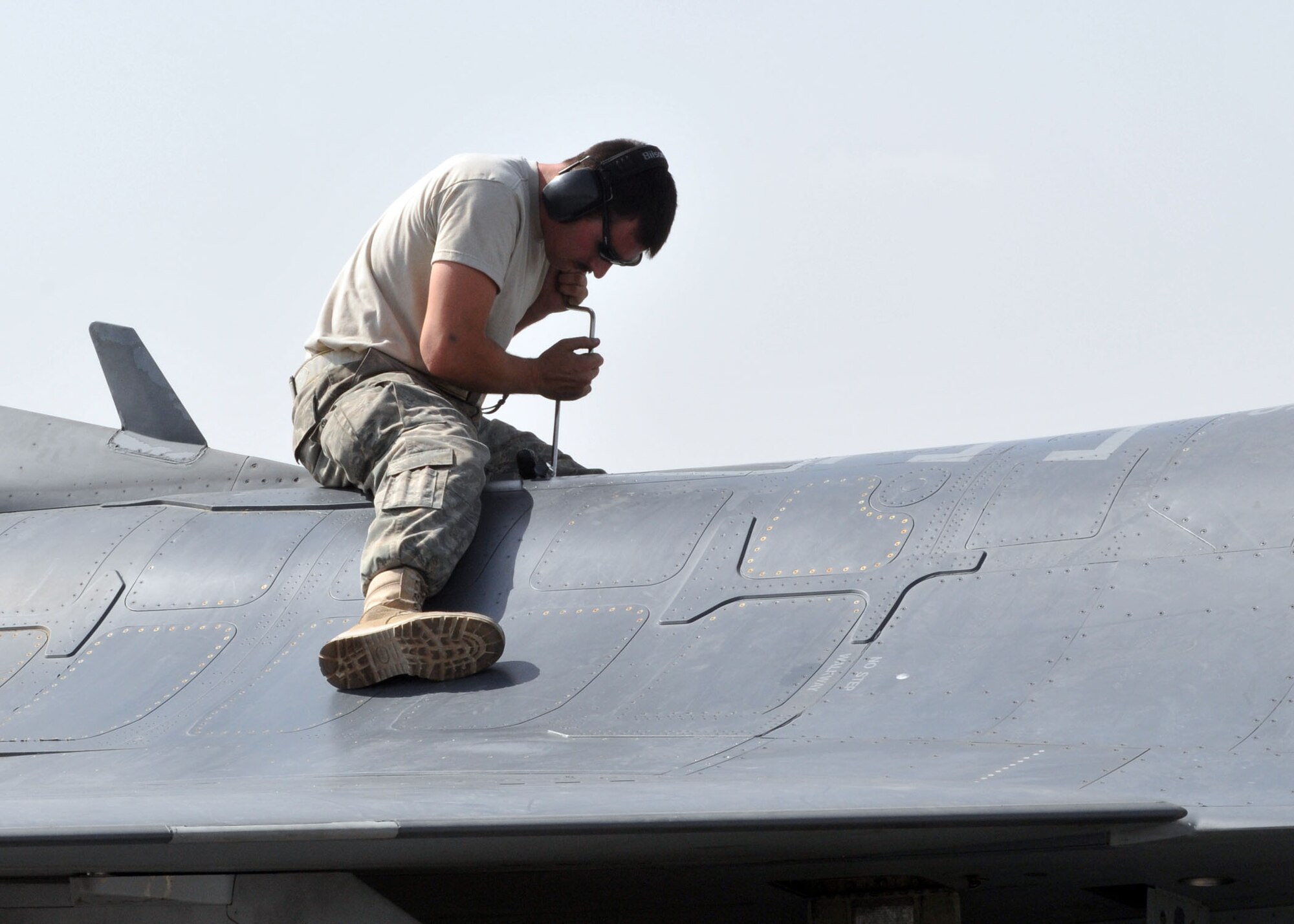BAGRAM AIRFIELD, Afghanistan -- Airman 1st Class Jeremy Fath, a crew chief from the 455th Expeditionary Aircraft Maintenance Squadron, loosens screws on a panel of an F-16 Fighting Falcon in order to begin inspecting the aircraft for broken pieces or anything out of the ordinary here, Aug. 30, 2009.  Airman Fath is deployed from Hill Air Force Base, Utah, and hails from Des Moines, Iowa.   The F-16 is a compact, multi-role fighter aircraft that is highly maneuverable in air-to-air combat and air-to-surface attacks.  (U.S. Air Force photo/Senior Airman Felicia Juenke)