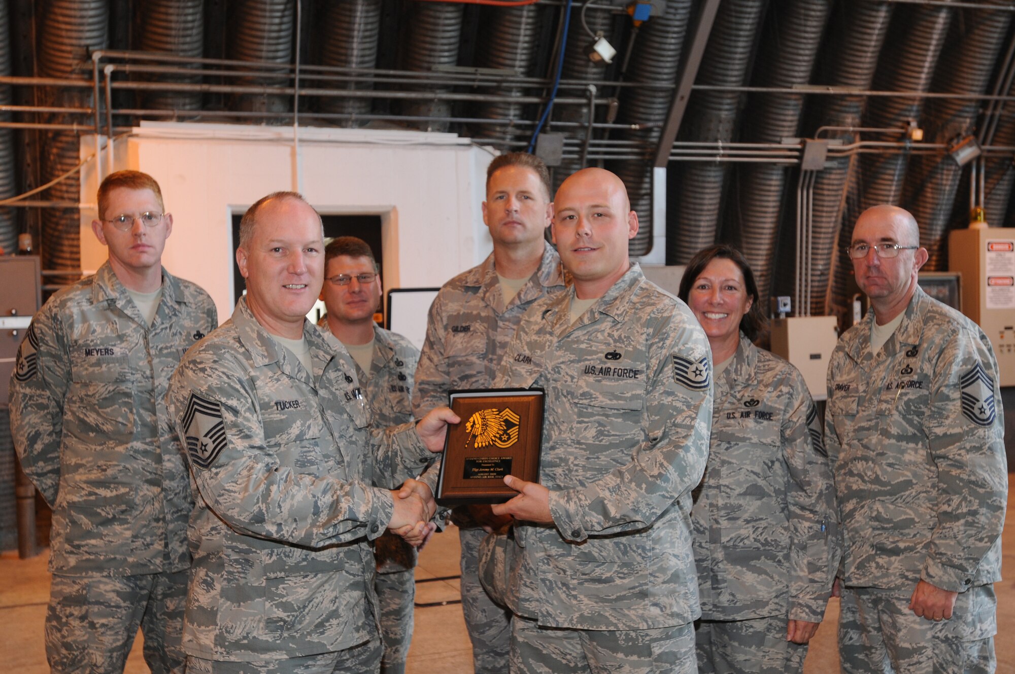 Tech. Sgt. Jeremy Clark, 31st Maintenance Squadron, recieves the Aviano Chief's Choice Award for August 2009 from Chief Master Sgt. Bruce Tucker, 31st Maintenance Group chief enlisted manager, along with fellow Aviano chiefs and chief selects. (U.S. Air Force photo/ Staff Sgt. Patrick Dixon)