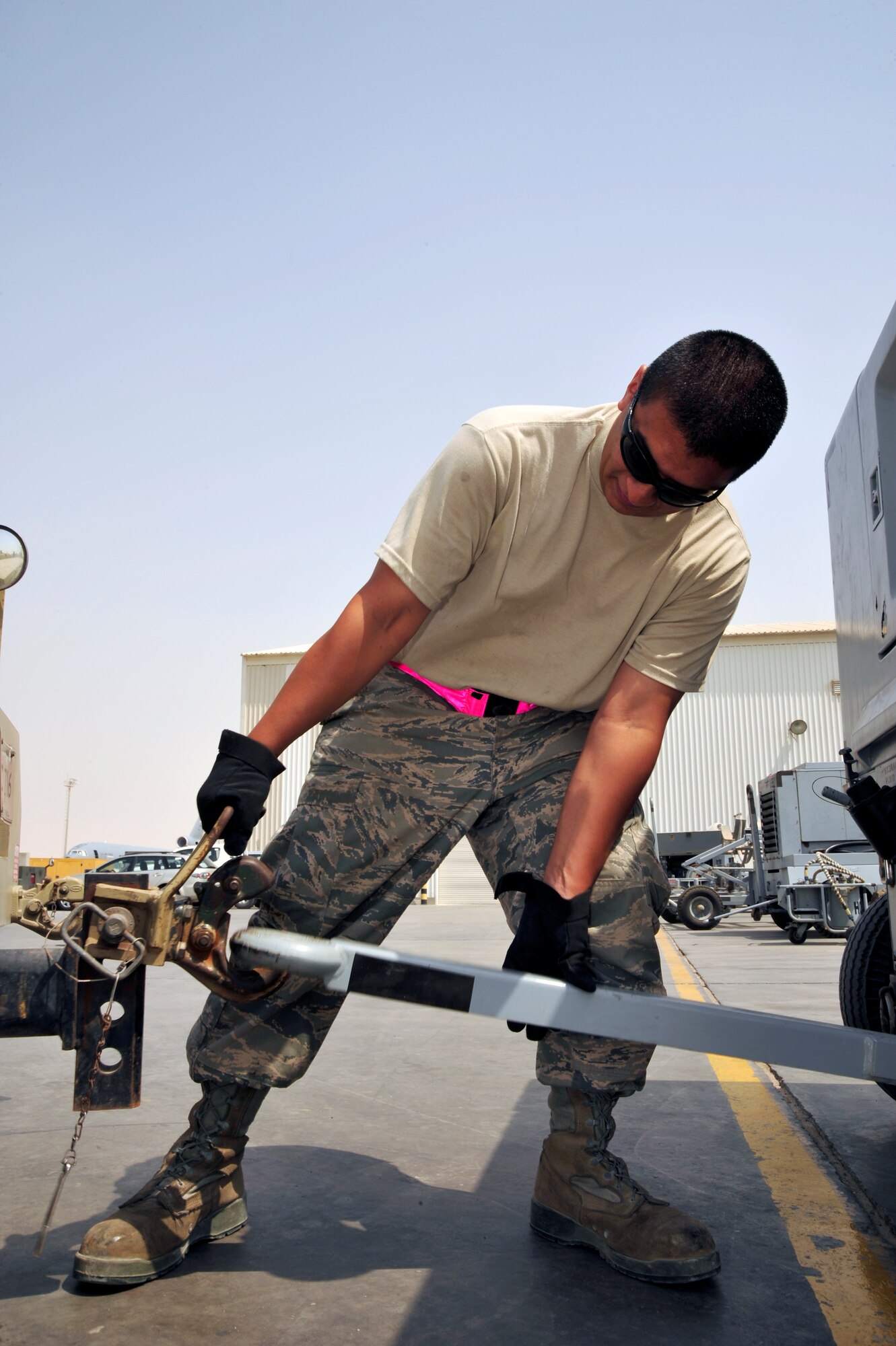 SOUTHWEST ASIA -Senior Airman Michael Villarreal, 380th Expeditionary Maintenance Squadron, attaches a hydraulic test cart to a bobtail before delivering it to an aircraft Sept. 2, 2009. Airman Villarreal is deployed from Beale Air Force Base, Calif., and grew up in Los Angeles, Calif. (U.S. Air Force photo/Tech. Sgt. Charles Larkin Sr)