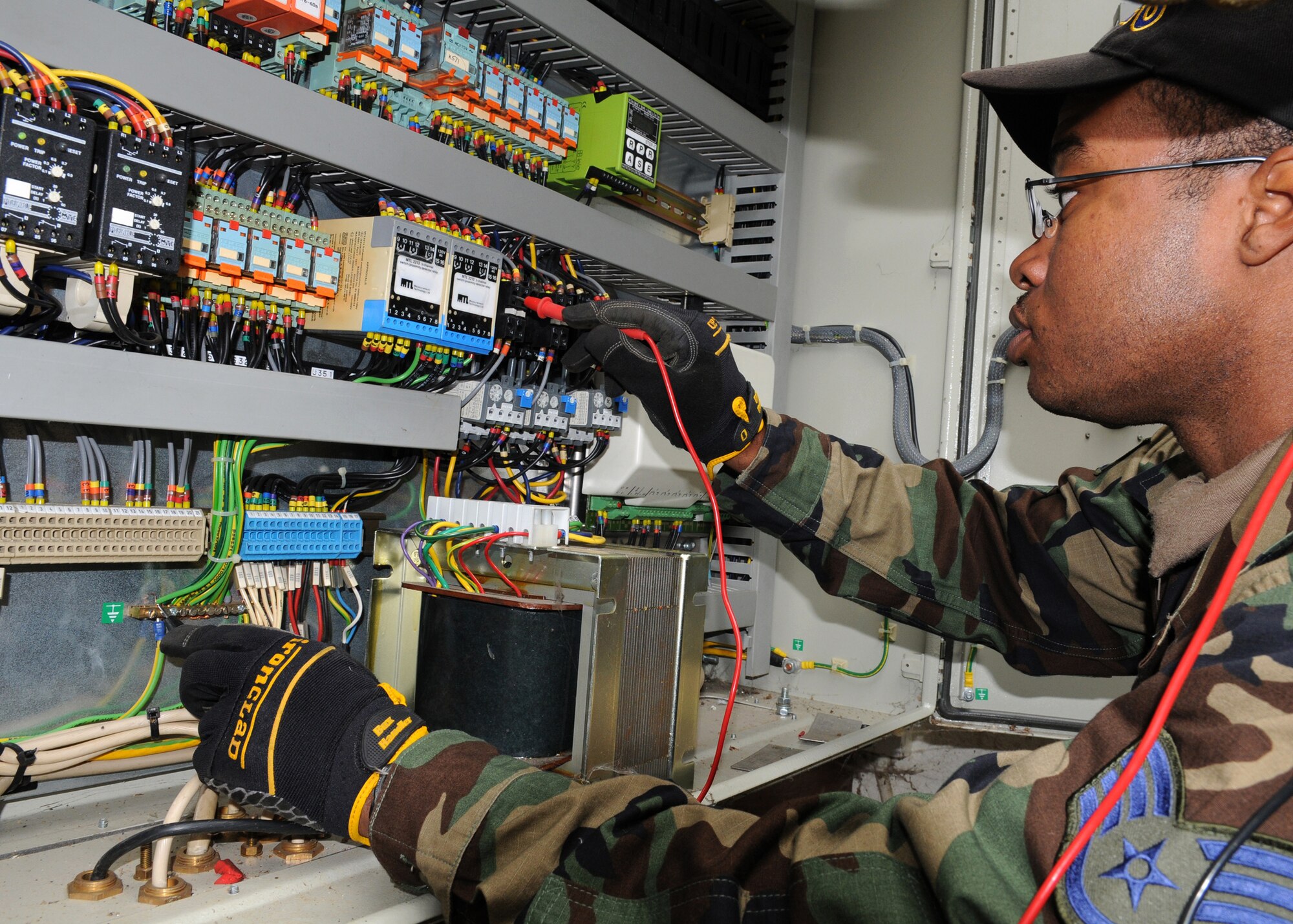 RAF MILDENHALL, England – Staff Sgt. Taraus Boyd, 100th Civil Engineer Squadron, electrical technician craftsman, checks for proper voltage using a multimeter during troubleshooting procedures at the waste plant Sept. 3, 2009. Sgt. Boyd is trying to restore proper voltage to a pump that was not receiving adequate power. To find the problem area he must patiently check each individual wire to locate the faulty part. (U.S. Air Force photo by Staff Sgt. Jerry Fleshman)