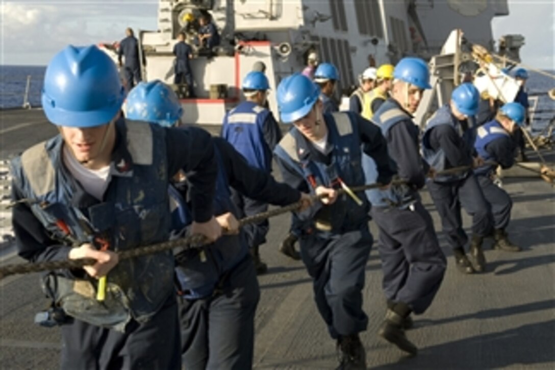 Line handlers aboard the guided-missile destroyer USS McCampbell (DDG 85) take in a line during an underway replenishment with fast combat support ship USNS Bridge (T-AOE 10) in the Pacific Ocean on Aug. 29, 2009.  