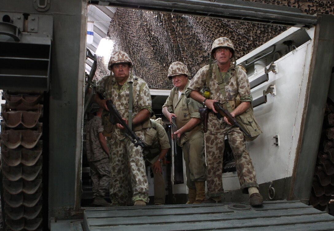 Jerry W. Berry, Michael S. Gunter and Denny R. Box, members of the WWII reenactors group, stand inside one of the original Landing Vehicle Tracked machines used in WWII, at the WWII and Korean War Museum at Camp Del Mar, Camp Pendleton Sept. 4.