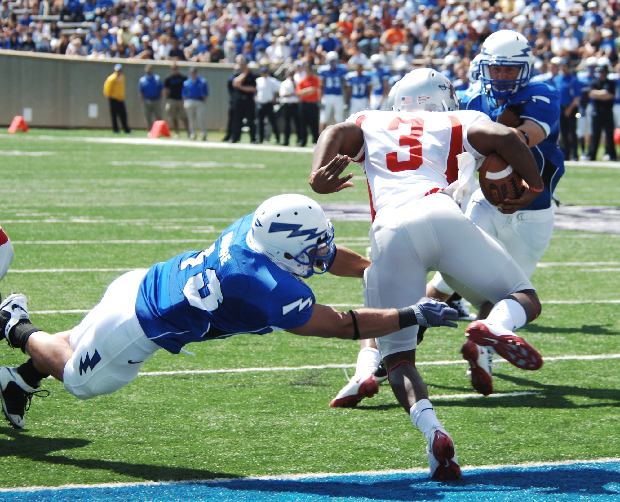 Nicholls State quarterback LaQuintin Caston escapes Falcons inside linebacker Justin Moore in his own end zone during Air Force's home opener at Falcon Stadium Sept. 5, 2009. The Falcons demolished the Colonels 72-0. Moore, a senior, is from Columbus, Ohio. Caston is a native of Baton Rouge, La. (U.S. Air Force photo/John Van Winkle)