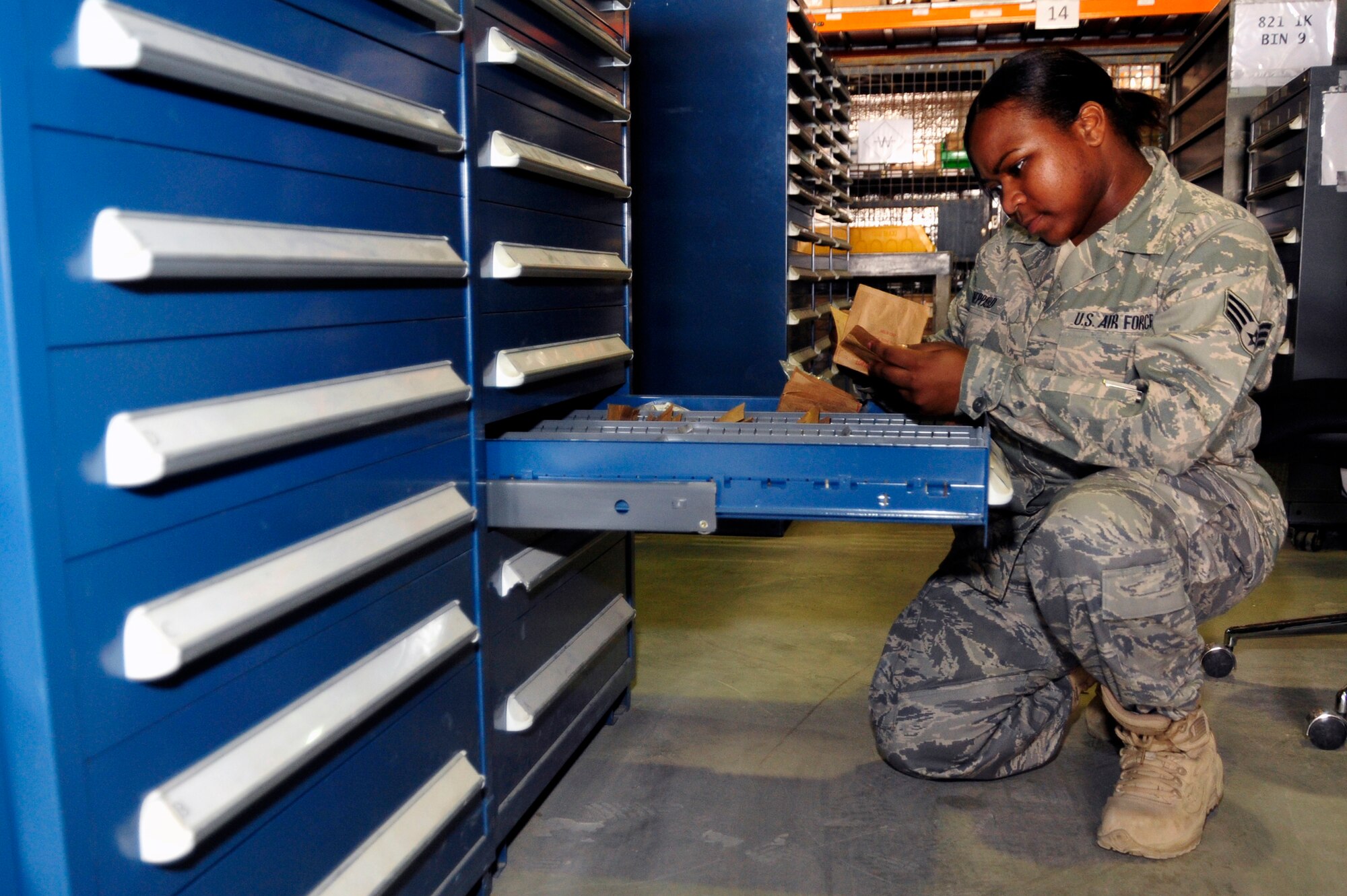 SOUTHWEST ASIA -Senior Airman Athena Sheppard, 380th Expeditionary Logistics Readiness Squadron, checks expiration dates of items in supply Sept. 4, 2009. Airman Sheppard is deployed from Kadena Air Base, Japan, and grew up in Macon, Ga. (U.S. Air Force photo/Tech. Sgt. Charles Larkin Sr)