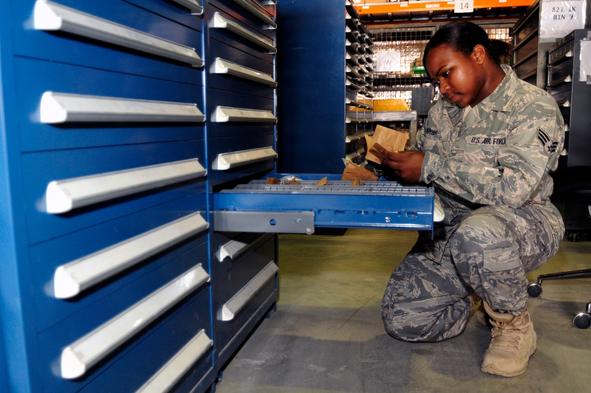 SOUTHWEST ASIA -Senior Airman Athena Sheppard, 380th Expeditionary Logistics Readiness Squadron, checks expiration dates of items in supply Sept. 4, 2009. Airman Sheppard is deployed from Kadena Air Base, Japan, and grew up in Macon, Ga. (U.S. Air Force photo/Tech. Sgt. Charles Larkin Sr)