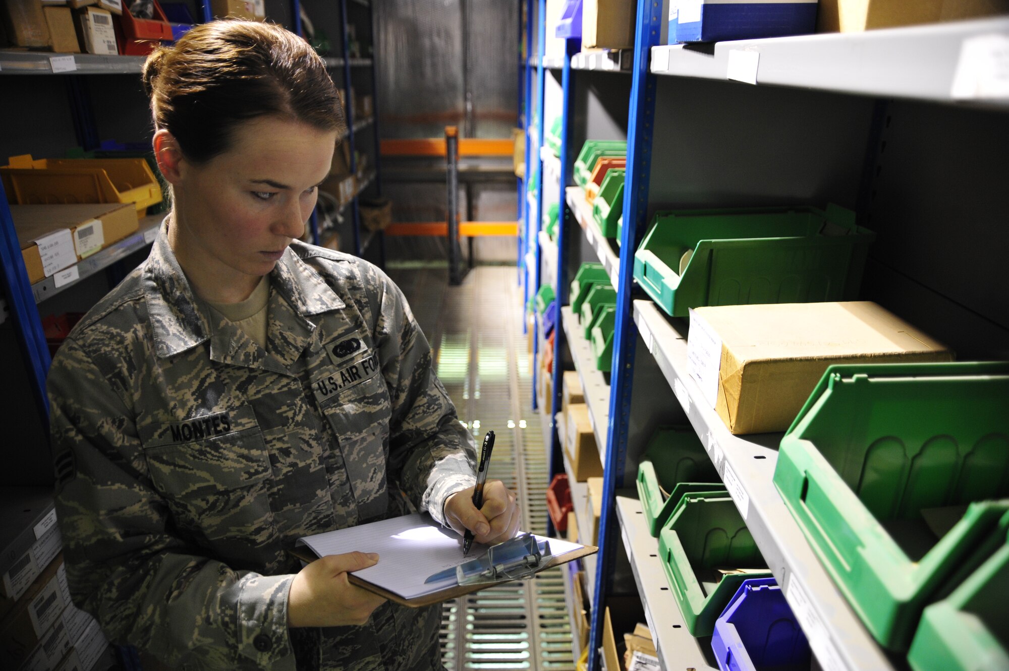 SOUTHWEST ASIA -Senior Airman Megan Montes, 380th Expeditionary Logistics Readiness Squadron, writes down national stock numbers and quantity of parts in stock Sept. 4, 2009. Airman Montes is deployed from MacDill Air Force Base, Fla., and grew up in Las Vegas, Nev. (U.S. Air Force photo/Tech. Sgt. Charles Larkin Sr)