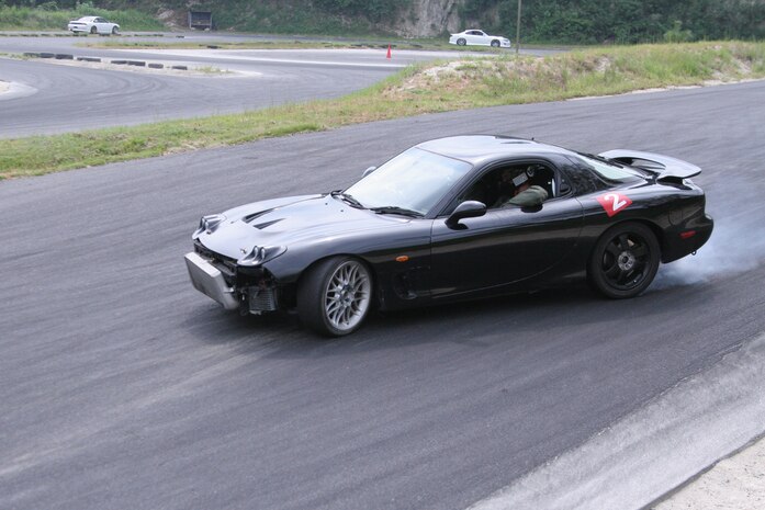 Cpl. Greg Fitts, training noncommissioned officer for the Provost Marshal’s office here, begins his drift before negotiating an upcoming turn at Barefoot Heaven Circuit in Kuga, Japan Sep. 5. Fitts has been drift racing for nearly two years. Drift racing is a motor sport that involves the driver deliberately over steering his vehicle while maintaining strong control during turns. Cpl. Fitts wears several pieces of personal protective equipment while racing.