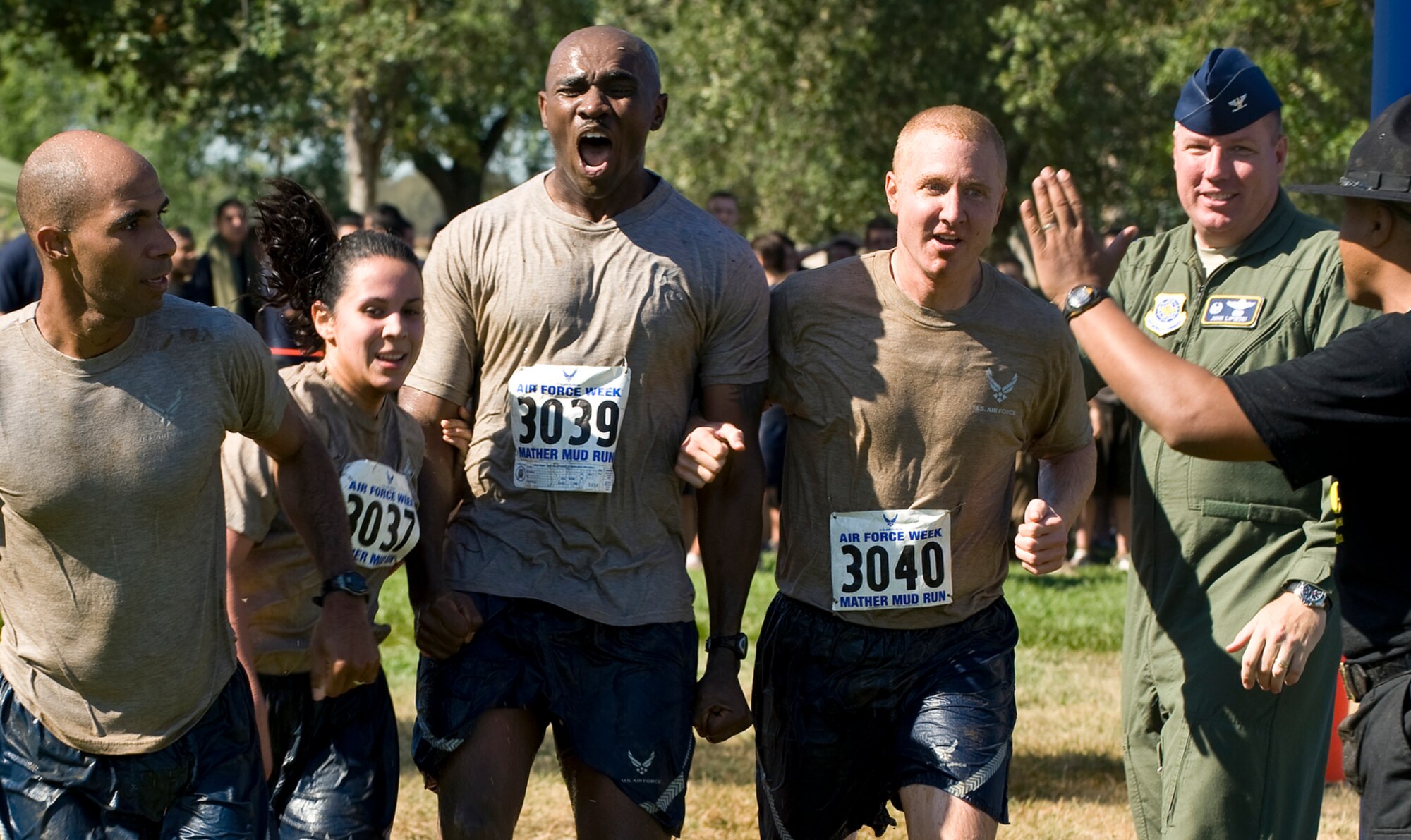 Members of the 615th Contingency Response Wing team cross the finish line together after completing the 10th Annual Mather Mud Run in Rancho Cordova, Calif., Sept. 5, 2009. during Air Force Week Sacramento. (U.S. Air Force photo/Staff Sgt. Bennie J. Davis III) 