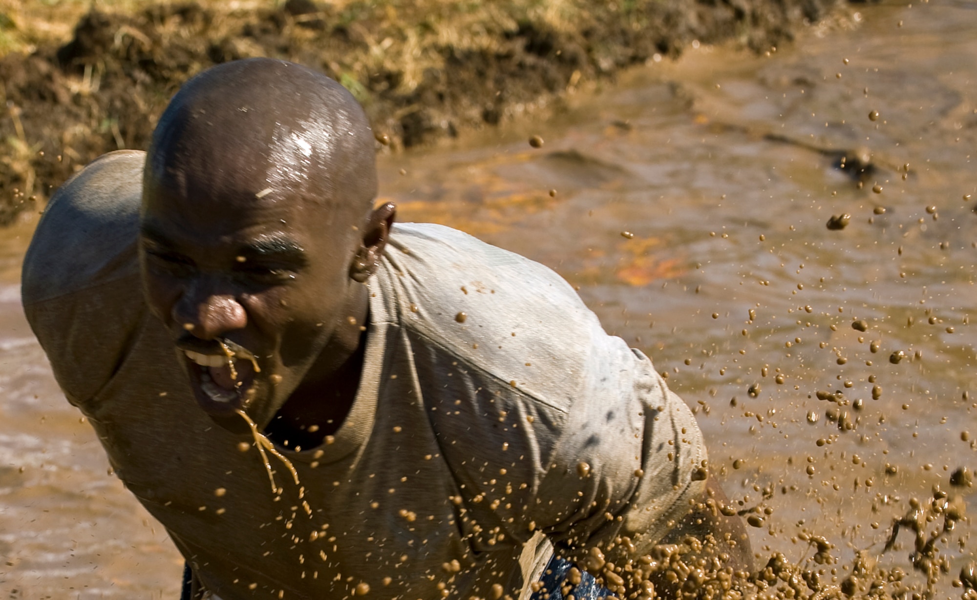 Master Sgt. Corey Gatewood screams while trekking through the mud during the last lap of a 5-mile course at the Mather Mud Run in Rancho Cordova, Calif., Sept. 5, 2009, for Air Force Week Sacramento. Master Sgt. Gatewood is a member of the 615th Contingency Response Wing at Travis Air Force Base, Ca. (U.S. Air Force photo/Staff Sgt. Bennie J. Davis III)