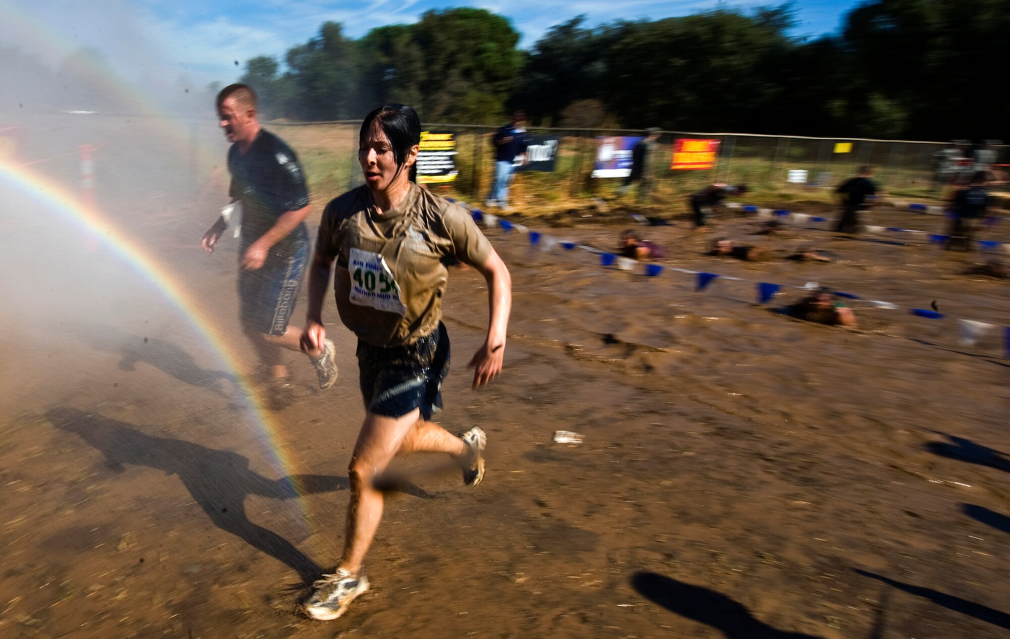 Second Lieutenant Holly Hess races through the mud while being sprayed clean by the Travis Air Force Base Fire Dept. during the 10th Annual Mather Mud Run in Rancho Cordova, Calif., Sept. 5, 2009, for Air Force Week Sacramento. Lieutenant Hess is a public affairs officer with the 60th Air Mobility Wing at Travis AFB, Calif. (U.S. Air Force photo/Staff Sgt. Bennie J. Davis III) 