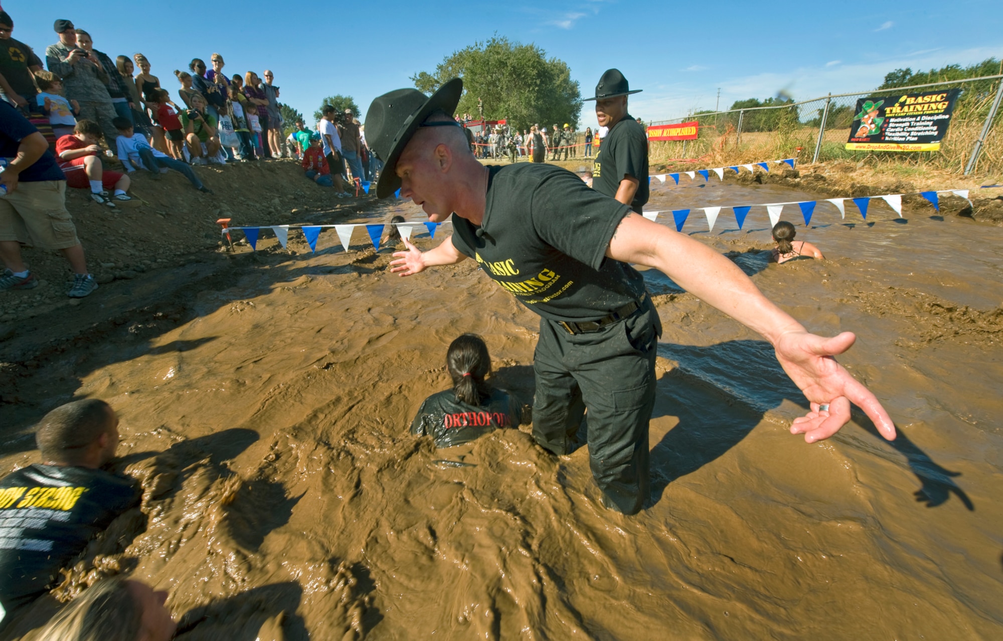 Drill Instructors from Marine Corps Recruit Depot San Diego motivate participants through the 10th Annual Mather Mud Run in Rancho Cordova, Calif., Sept. 5, 2009, for Air Force Week Sacramento. The Mud Run features a 5-mile or 2-mile obstacle course boot camp challenge with low walls, tunnel crawls, a tire run, hay bale jumps and a low-crawl mud pit.  (U.S. Air Force photo/Staff Sgt. Bennie J. Davis III) 
