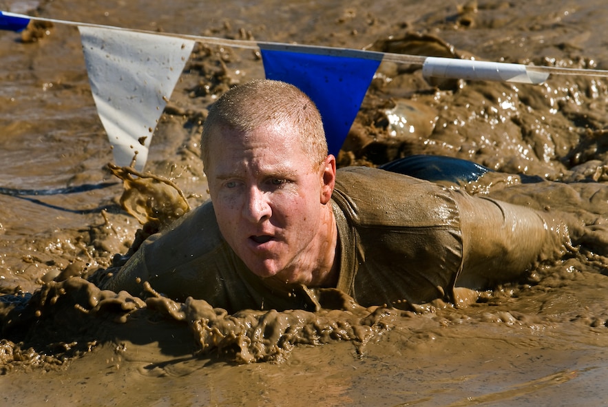 Master Sgt. Craig Brown crawls through the famed mud pit during the 10th Annual Mather Mud Run in Rancho Cordova, Calif., Sept. 5, 2009, during Air Force Week Sacramento. The Mud Run features a 5-mile or 2-mile obstacle course boot camp challenge with low walls, tunnel crawls, a tire run, hay bale jumps and a low-crawl mud pit. Sergeant Brown is a member of the 615th Contingency Response Wing at Travis Air Force Base, Calif. (U.S. Air Force photo/Staff Sgt. Bennie J. Davis III) 

