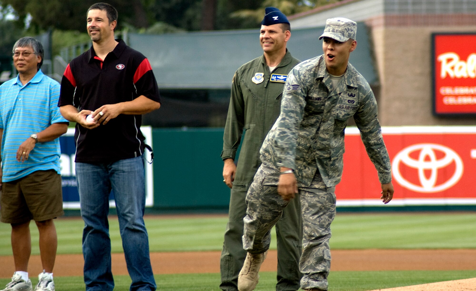 Senior Airman Daniel Williams, 60th Civil Engineer Squadron explosive ordnance disposal team member, throws the ceremonial first pitch at the Sacramento Rivercats game Aug. 28 at Raley Field as Col. Jim Vechery, 60th Air Mobility Wing commander looks on. (U.S. Air Force photo/ Senior Master Sgt. David Byron)