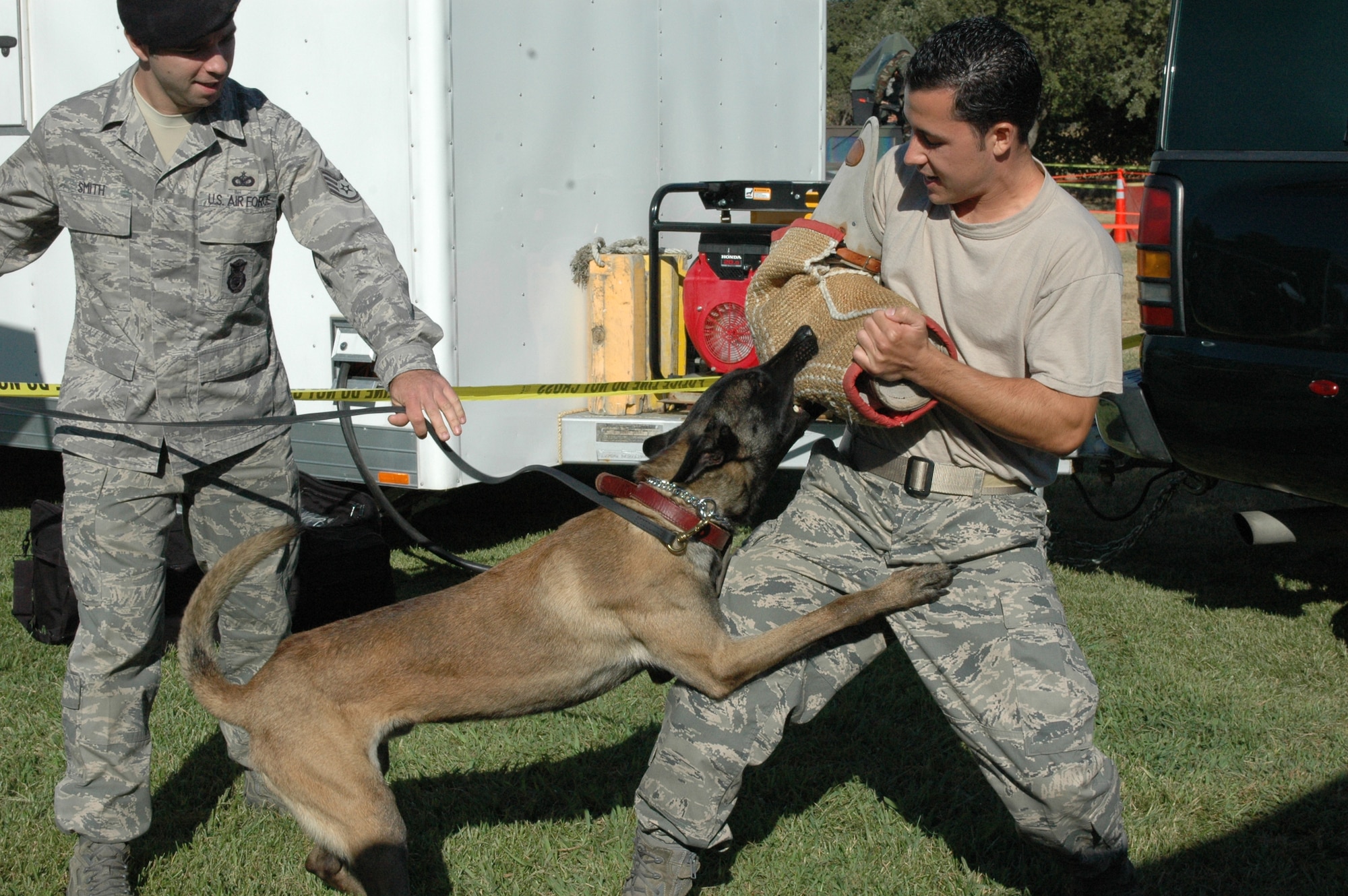 Members of the 60th Security Forces Squadron perform a military working dog demonstration at the Air Force Week Mather Mud Run Seot. 5 at Hagan Park in Rancho Cordova.(U.S. Air Force photo Senior Master Sgt. David Byron)