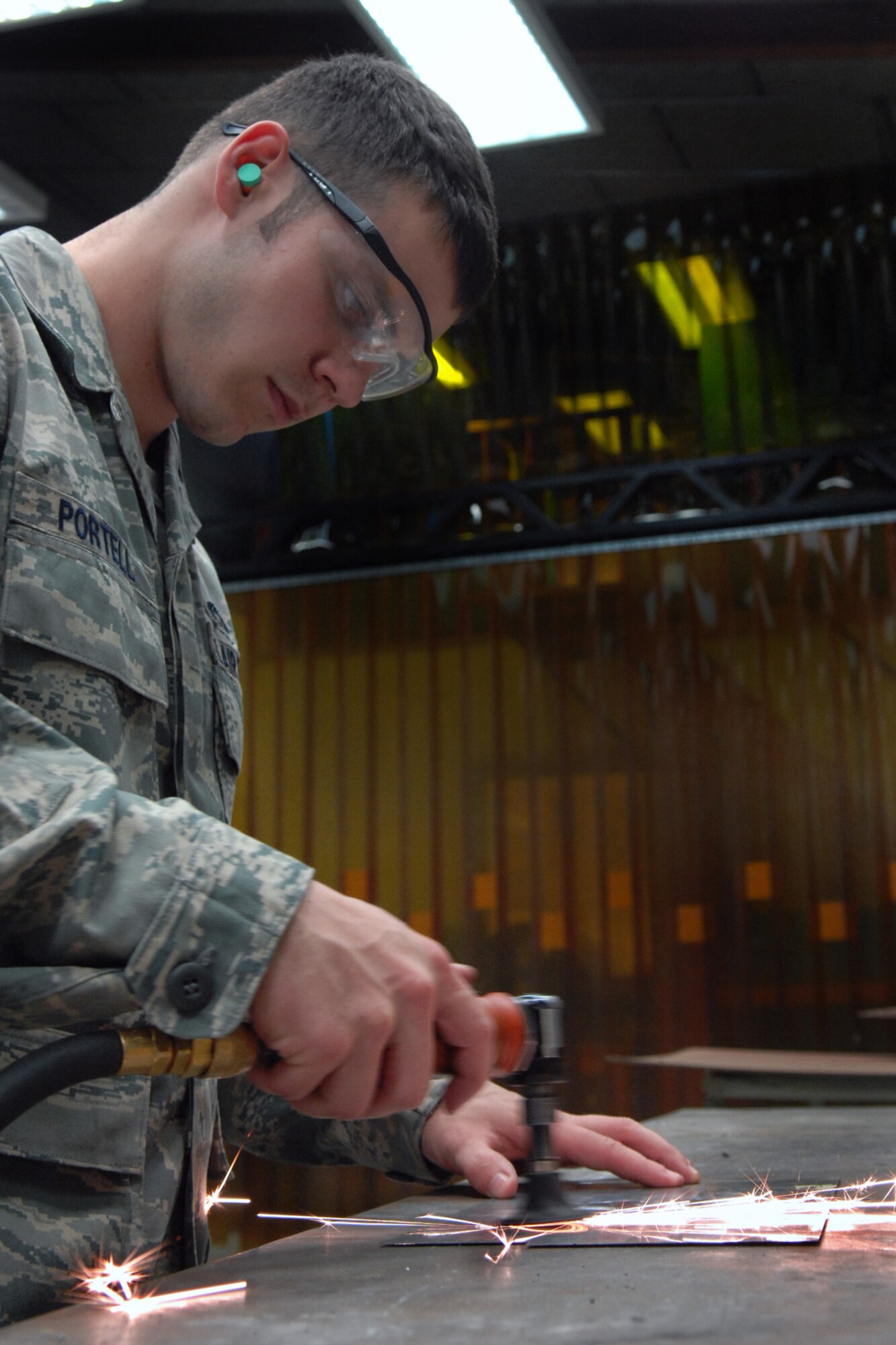 SPANGDAHLEM AIR BASE, Germany – Senior Airman Logan Portell, 52nd Equipment Maintenance Squadron metals technician, removes sharp edges from an A-10 Thunder Bolt II bracket Sept. 3. Metal technicians provide support to all the structural components of an aircraft. (U.S. Air Force photo/Airman 1st Class Staci Miller)