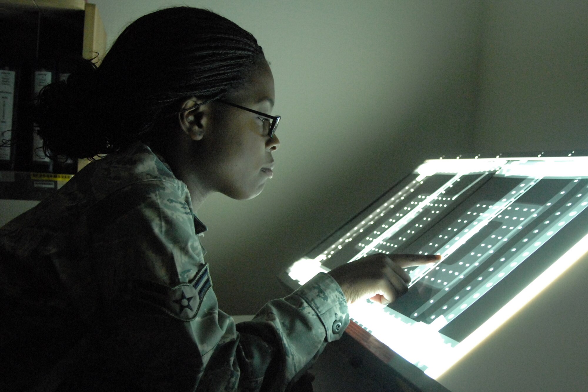 SPANGDAHLEM AIR BASE, Germany – Airman 1st Class Brigelle Langhorne, 52nd Equipment Maintenance Squadron nondestructive inspector, views film from an A-10 Thunder Bolt II pave penny pylon Sept. 3. The pylon supports the electronic countermeasures pod, one of the most successful ECM systems available. (U.S. Air Force photo/Airman 1st Class Staci Miller)