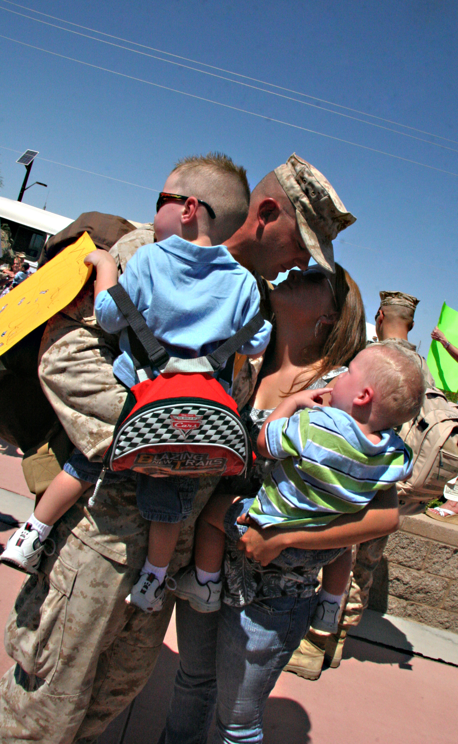 Sgt. Tony Tenhulzen, Marine Wing Support Squadron 371 combat engineer, is greeted by his wife, Megan, and two sons Aiden, left, and Jackson after returning to the Marine Corps Air Station in Yuma, Ariz., from a deployment to Afghanistan, Sept. 7, 2009. Approximately 150 Marines from MWSS-371 returned to the air station after the seven-month deployment supporting the 2nd Marine Expeditionary Brigade by constructing and maintaining airfields.