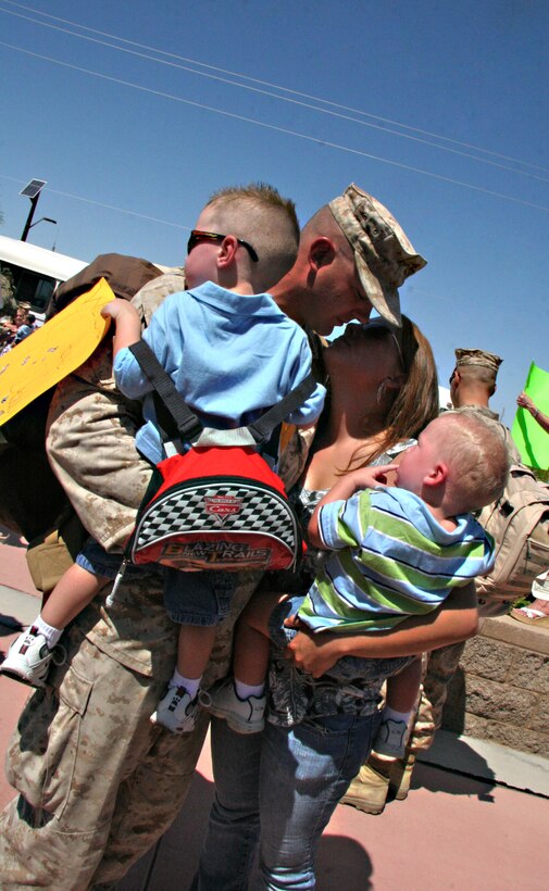 Sgt. Tony Tenhulzen, Marine Wing Support Squadron 371 combat engineer, is greeted by his wife, Megan, and two sons Aiden, left, and Jackson after returning to the Marine Corps Air Station in Yuma, Ariz., from a deployment to Afghanistan, Sept. 7, 2009. Approximately 150 Marines from MWSS-371 returned to the air station after the seven-month deployment supporting the 2nd Marine Expeditionary Brigade by constructing and maintaining airfields.